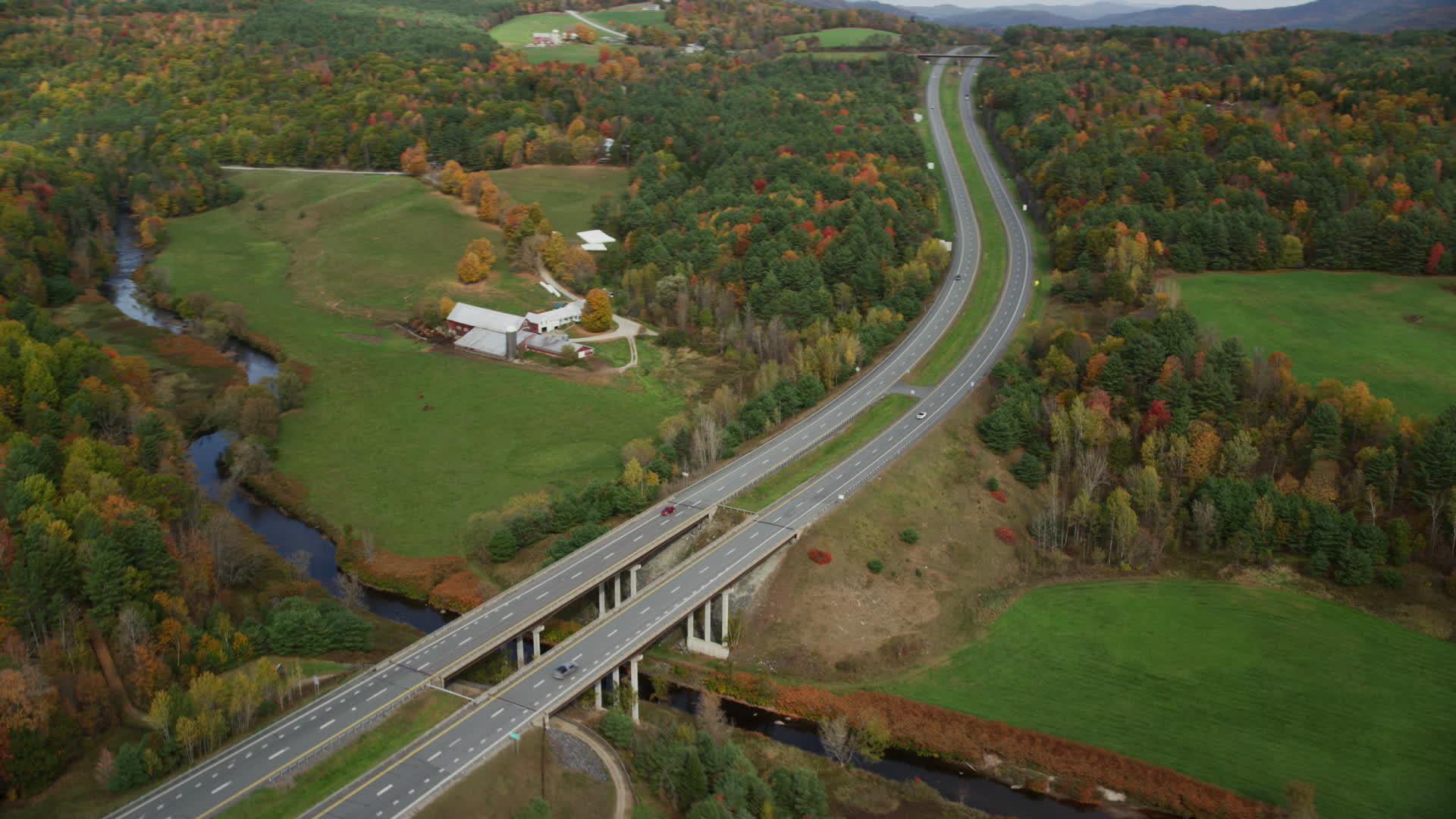 6K stock footage aerial video approaching a small bridge, Interstate 91