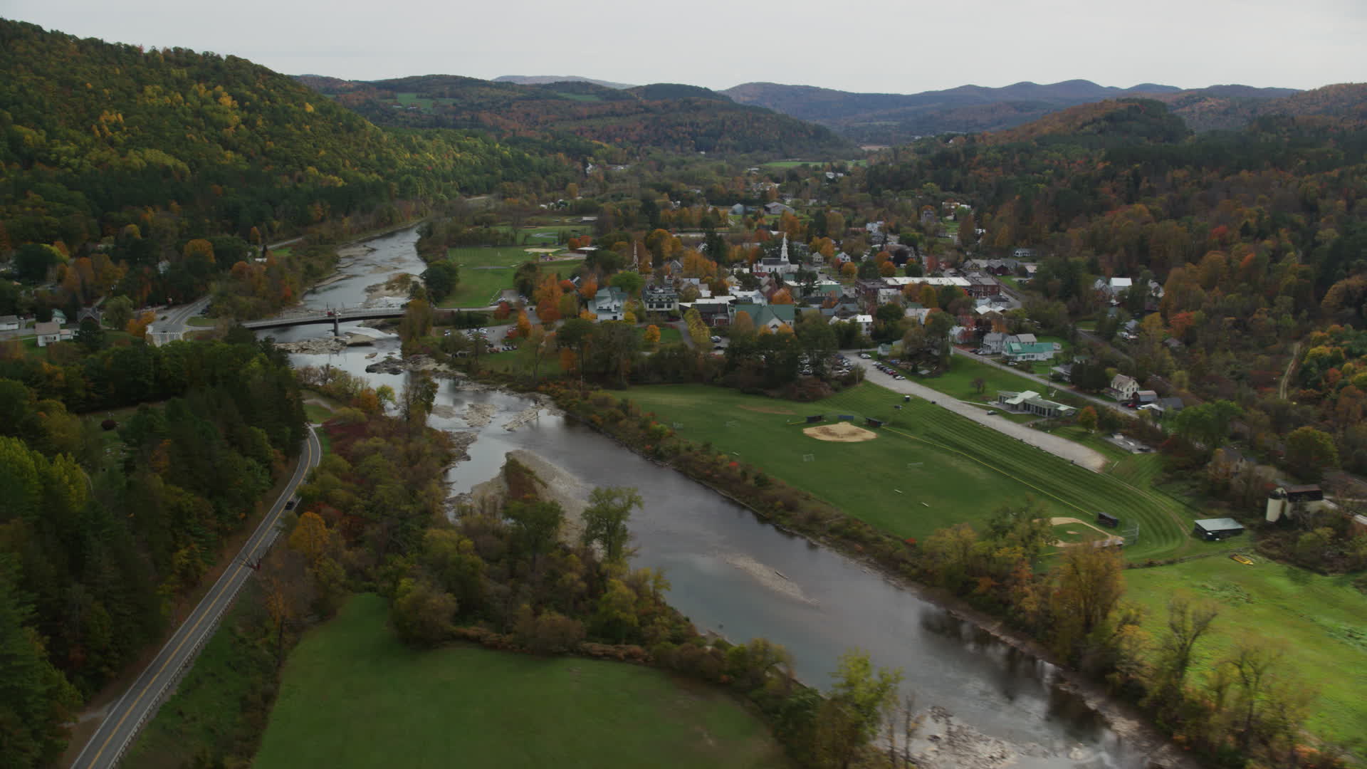 5.5K stock footage aerial video flying by small bridge, White River