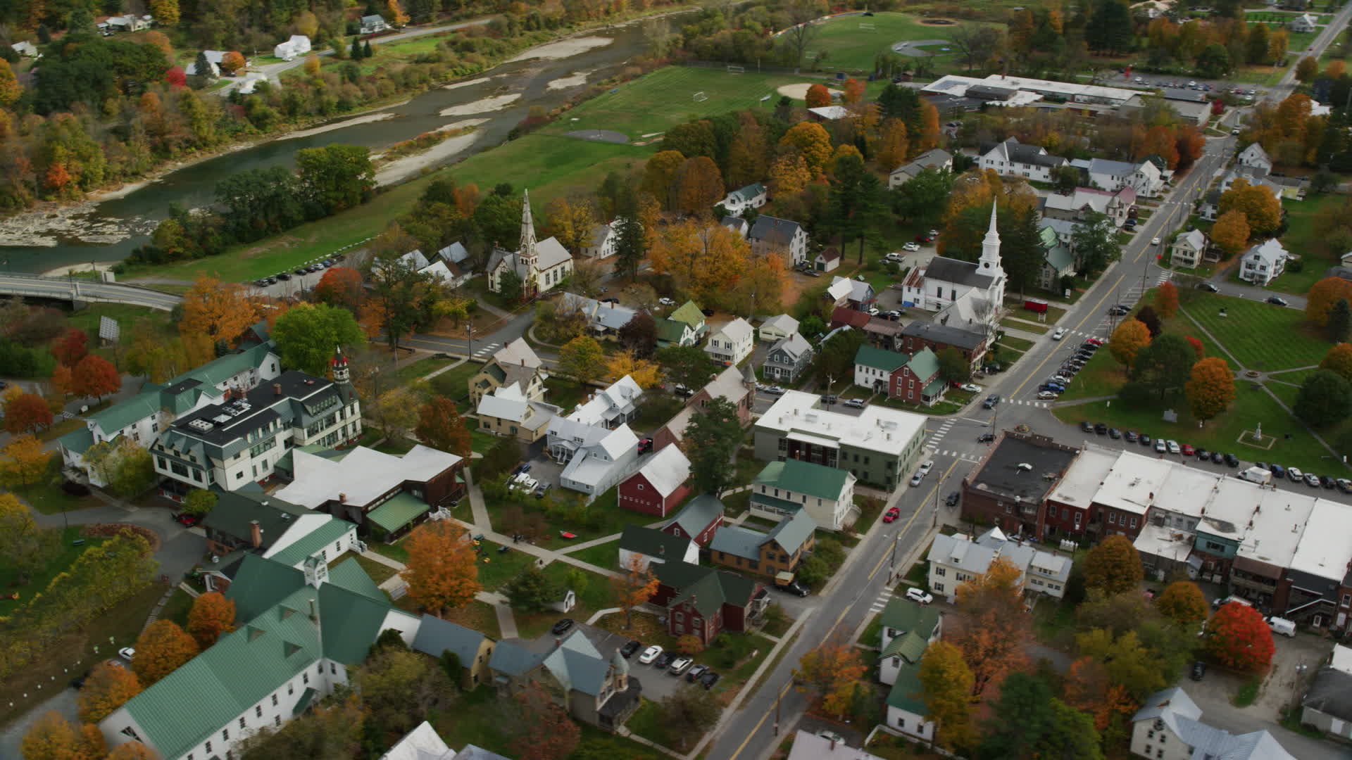 5.5K stock footage aerial video orbiting town square, churches, small rural town in autumn