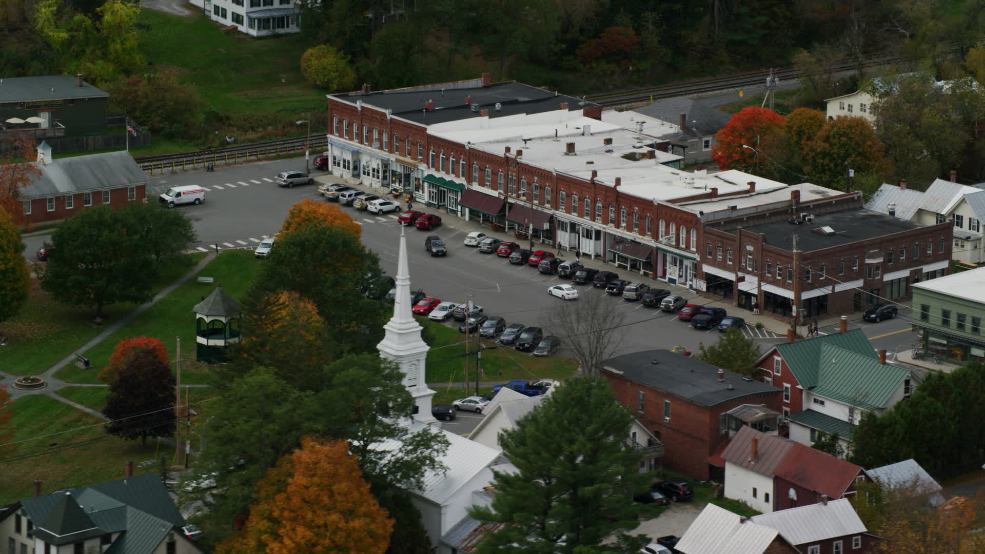 5.5K stock footage aerial video orbiting a row of shops near town square, small rural town