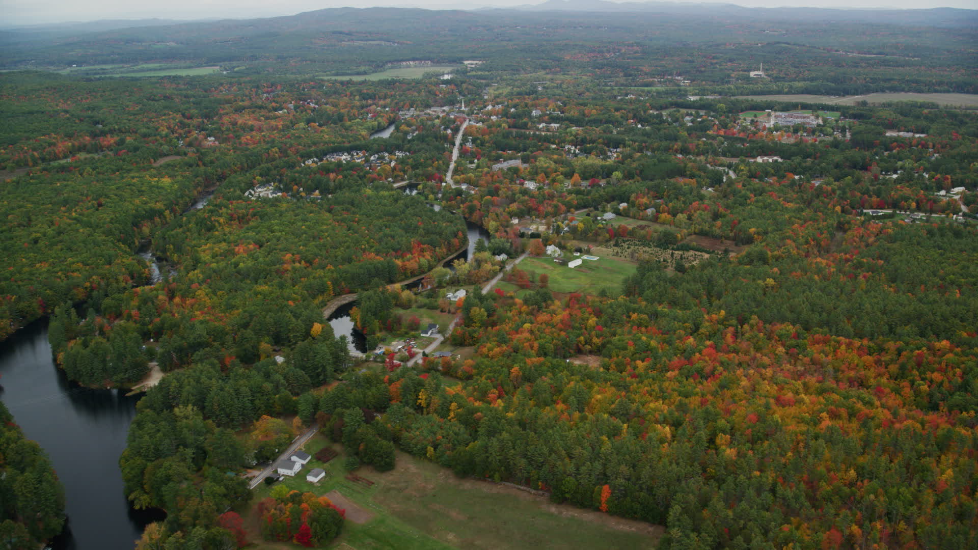 6K stock footage aerial video approaching small rural town, river