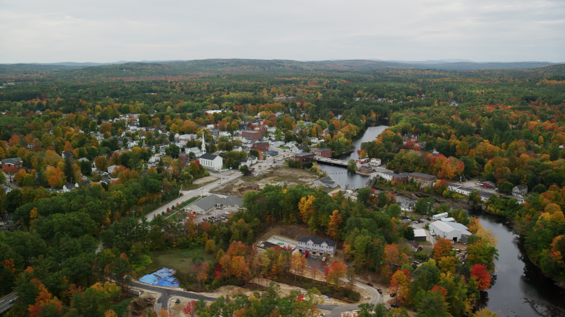 5.5K stock footage aerial video orbiting small town, Contoocook River