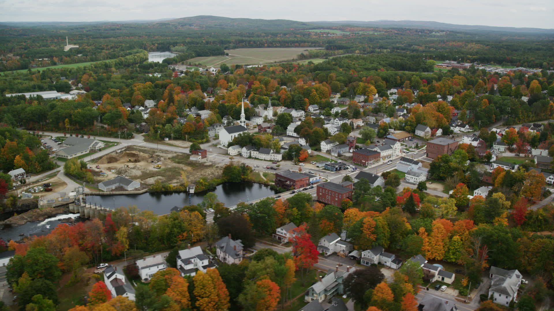 5.5K stock footage aerial video orbiting small town, church, dam