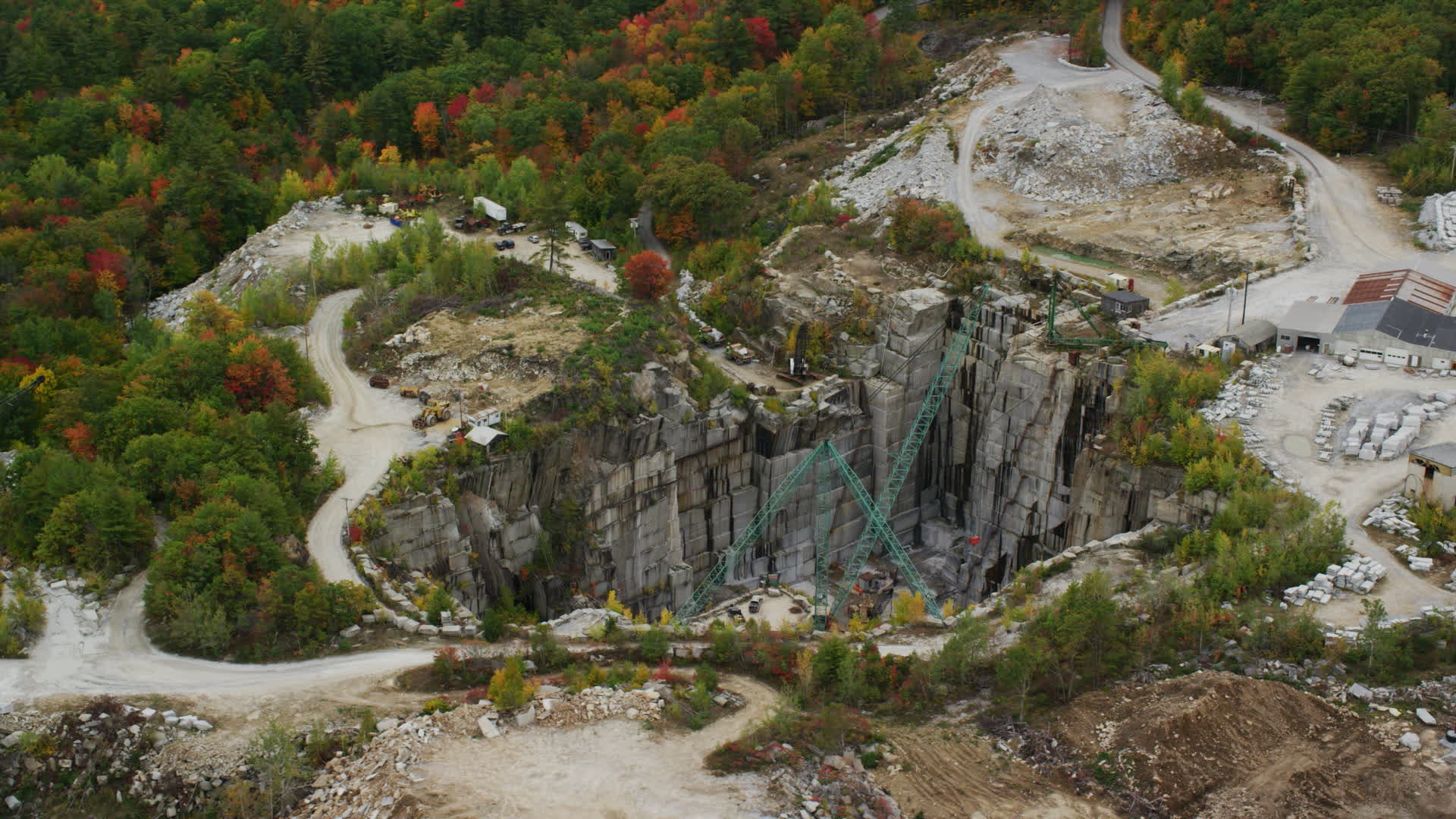 5.5K stock footage aerial video orbiting a quarry, large cranes
