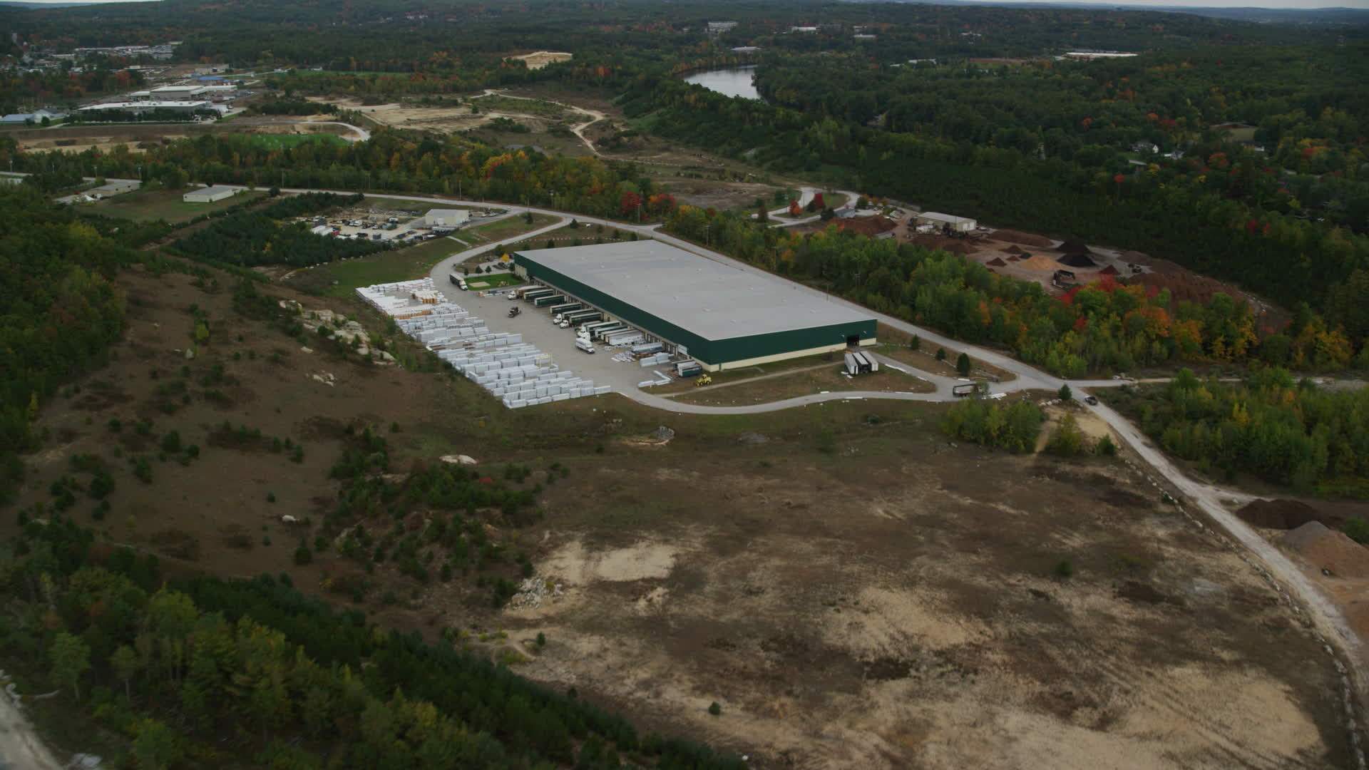5.5K stock footage aerial video over quarry, approach warehouse