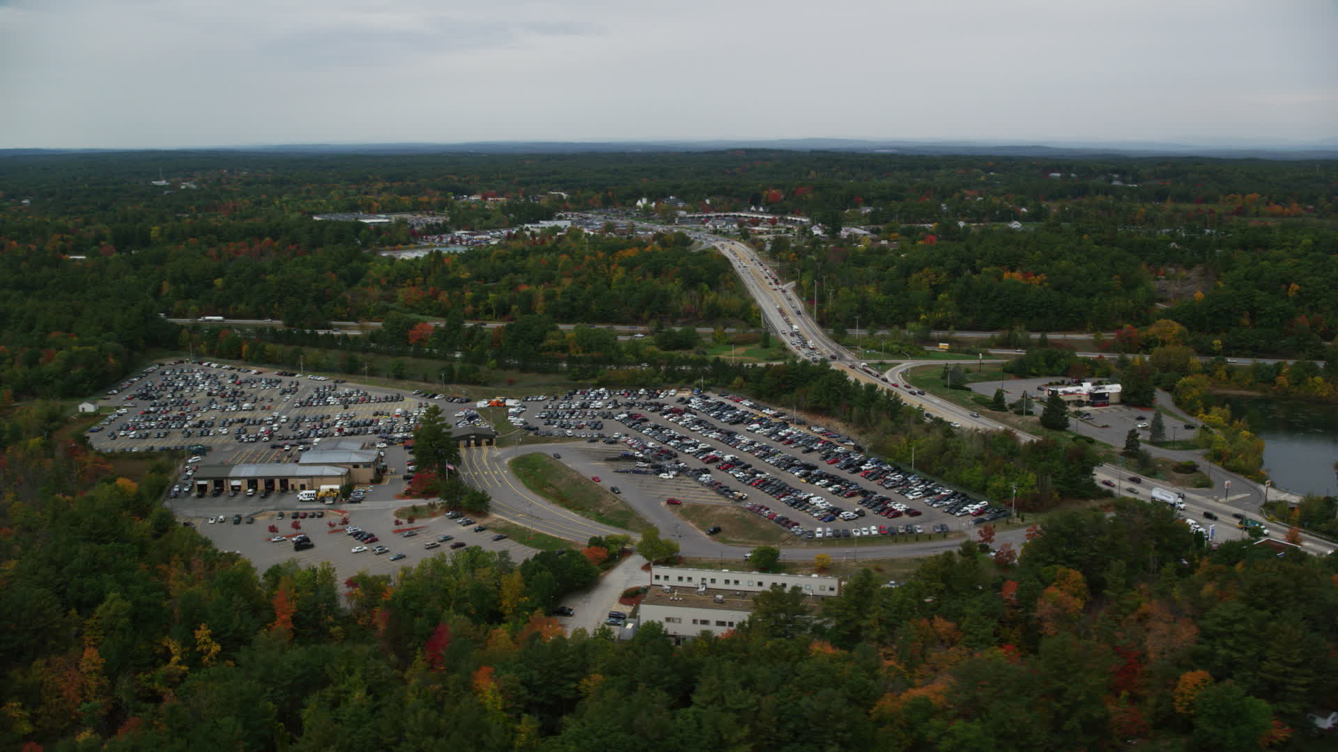 6K stock footage aerial video flying by a car auction area, autumn, overcast, Derry, New
