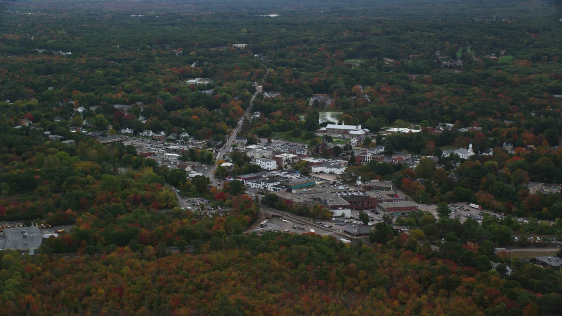 6K stock footage aerial video flying over fall foliage toward small
