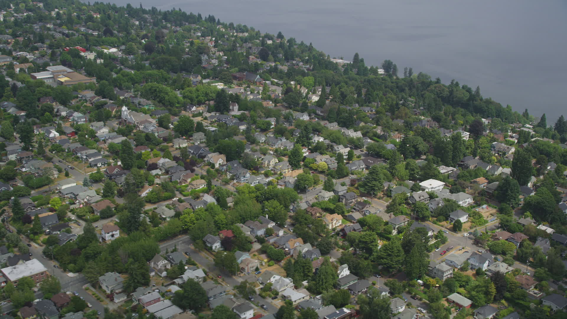 5K stock footage aerial video flying by residential neighborhood with trees, Madrona, Seattle