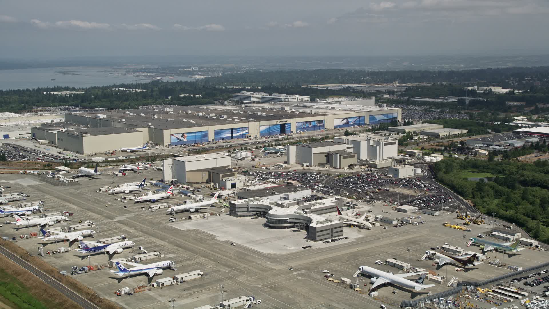 5K stock footage aerial video of Boeing Everett Factory and rows of
