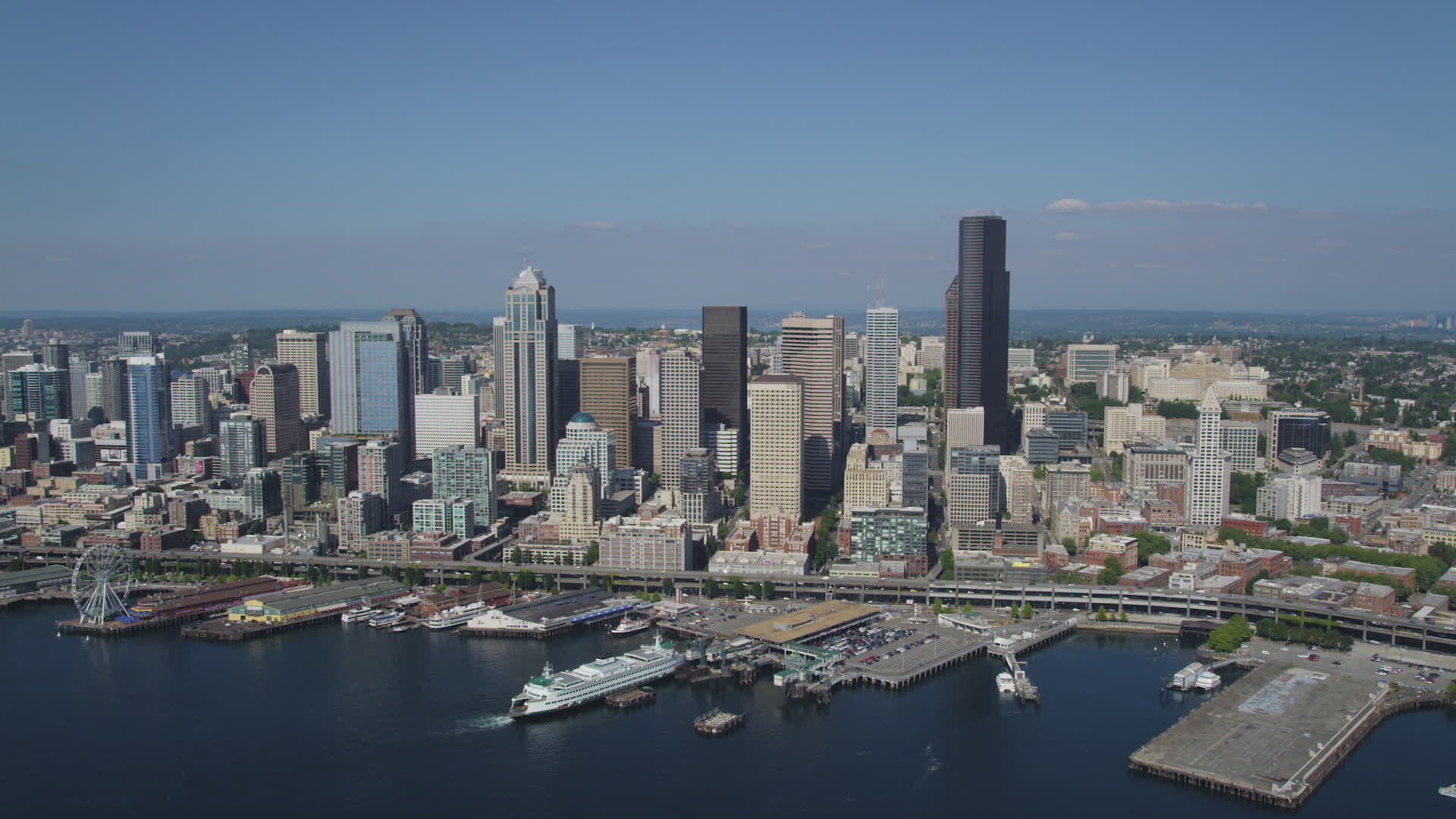 5k stock footage aerial video approach downtown seattle skyline and fly over the seattle ferry terminal on the waterfront washington aerial stock seattle city scape