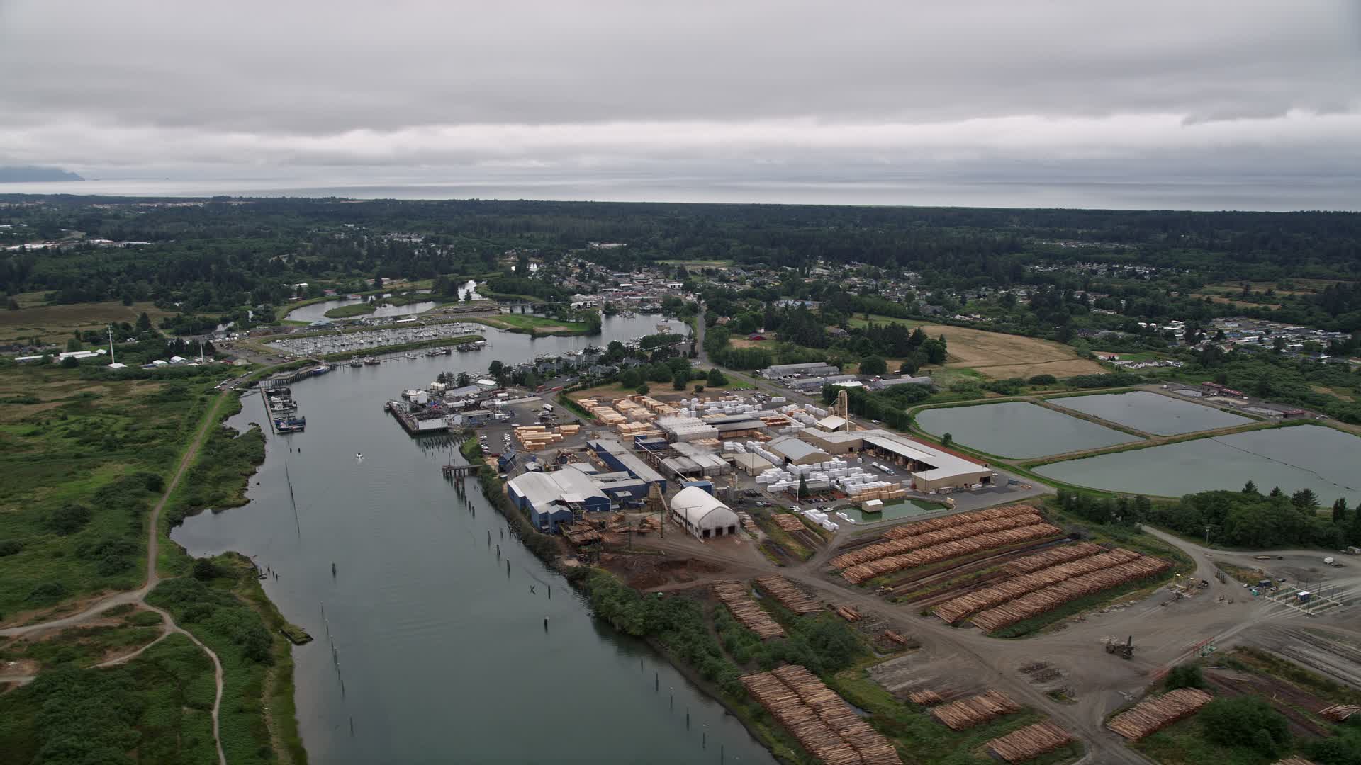 5K stock footage aerial video of a large lumber mill beside the