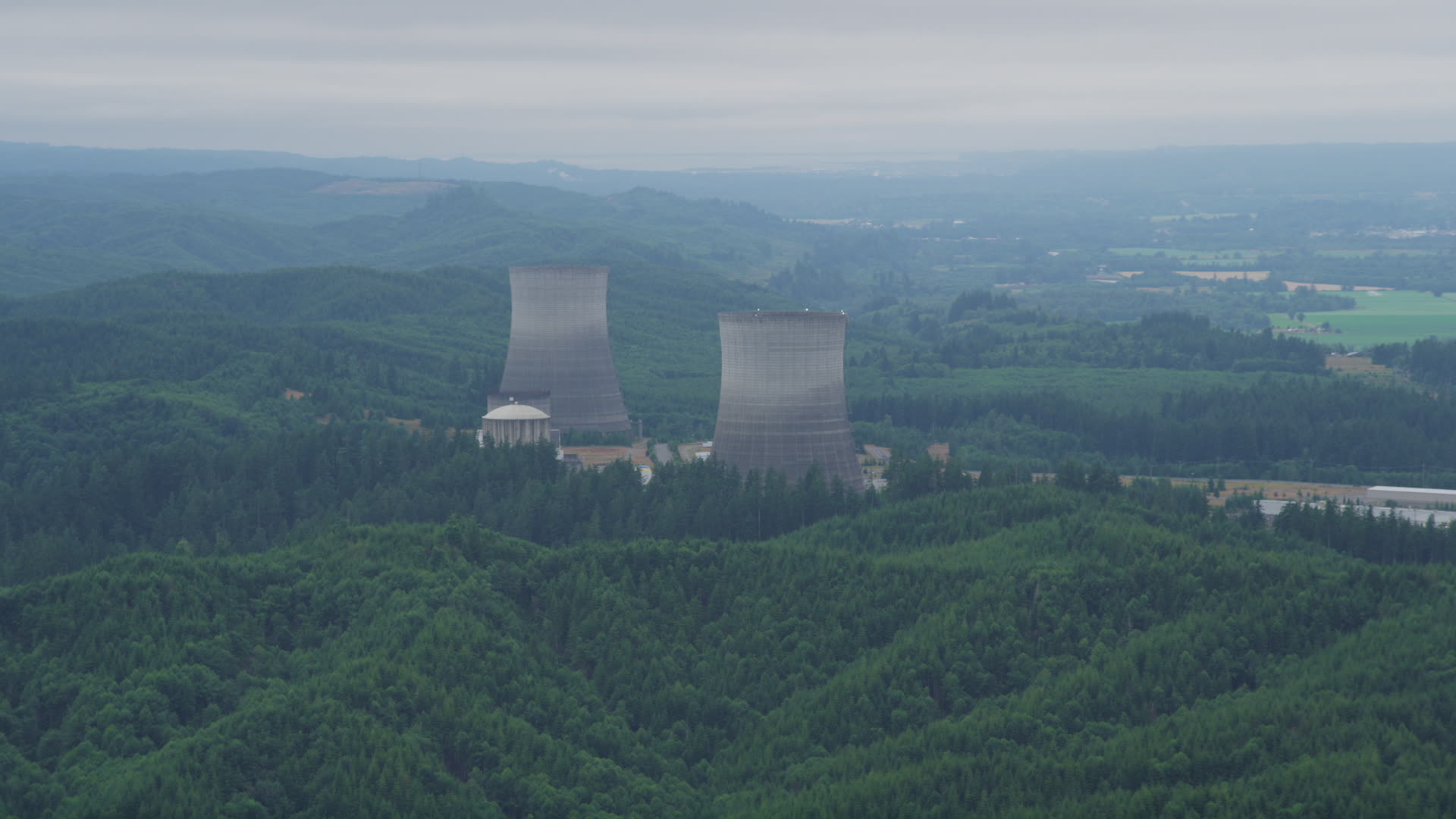 5K stock footage aerial video of a pair of cooling towers at the Satsop