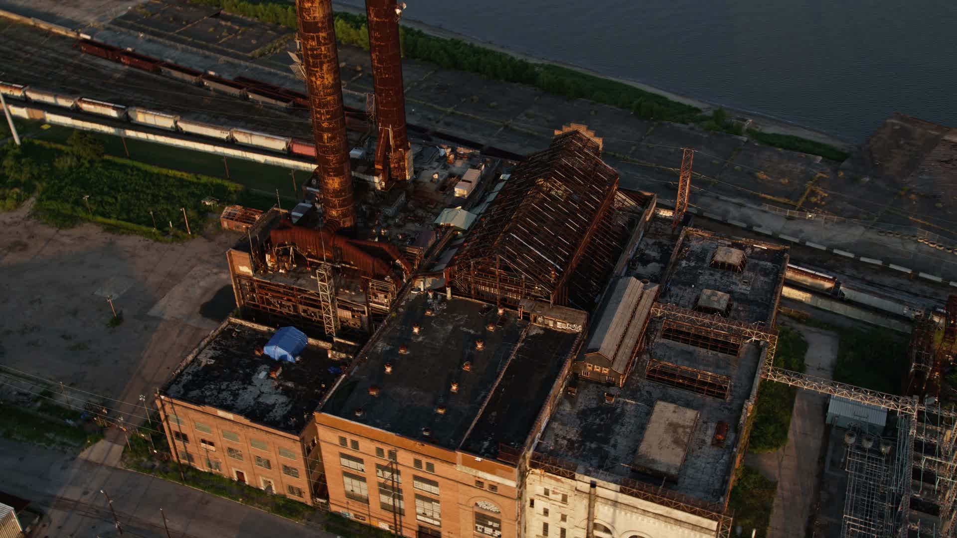 5K stock footage aerial video old power plant on bank of