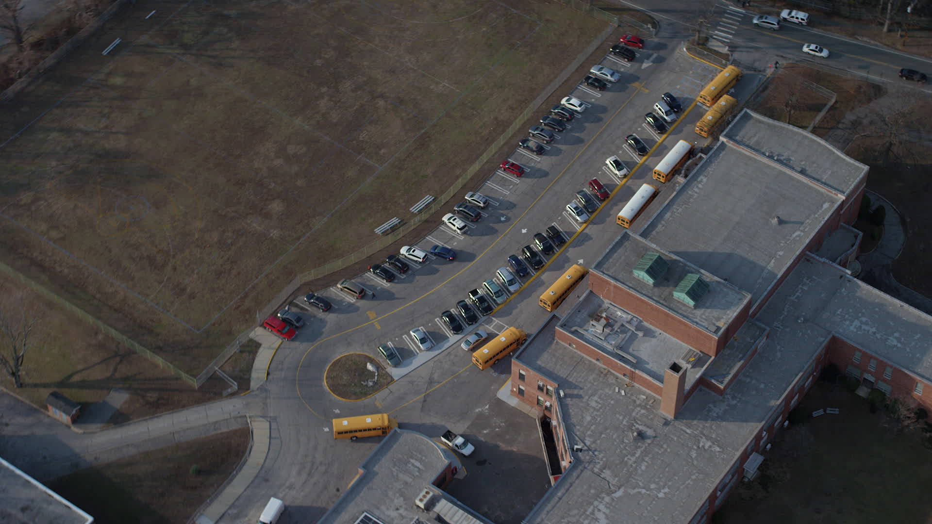 5K stock footage aerial video tilt to bird's eye view of school busses