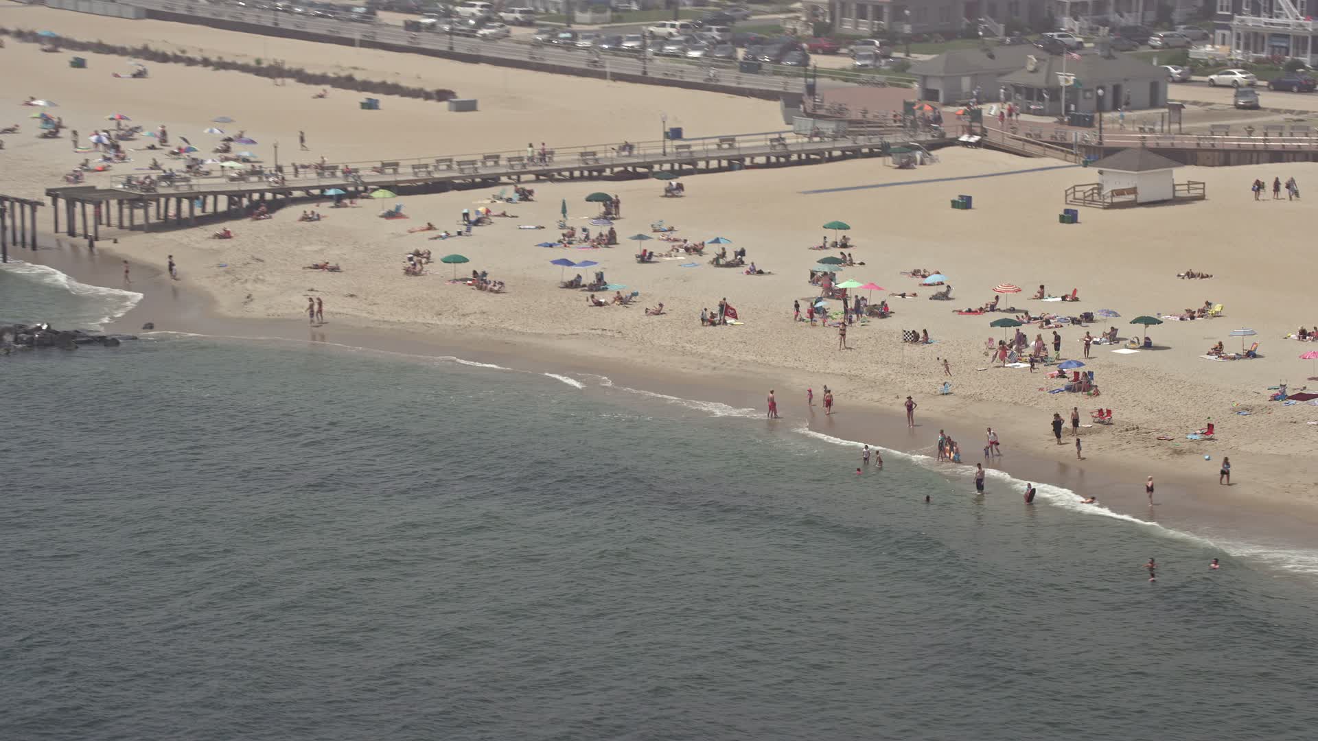 5.1K stock footage aerial video of sunbathers and boardwalk on the