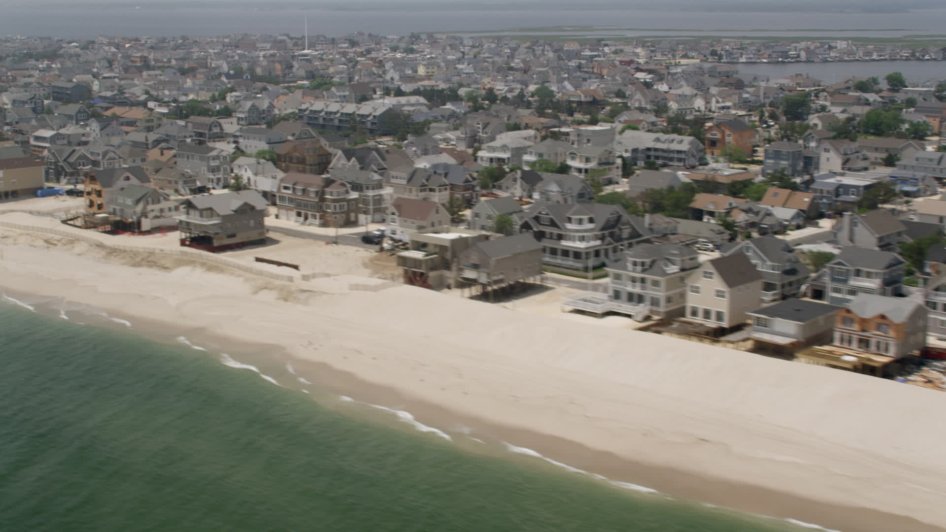 5K stock footage aerial video beachfront homes and a people on the