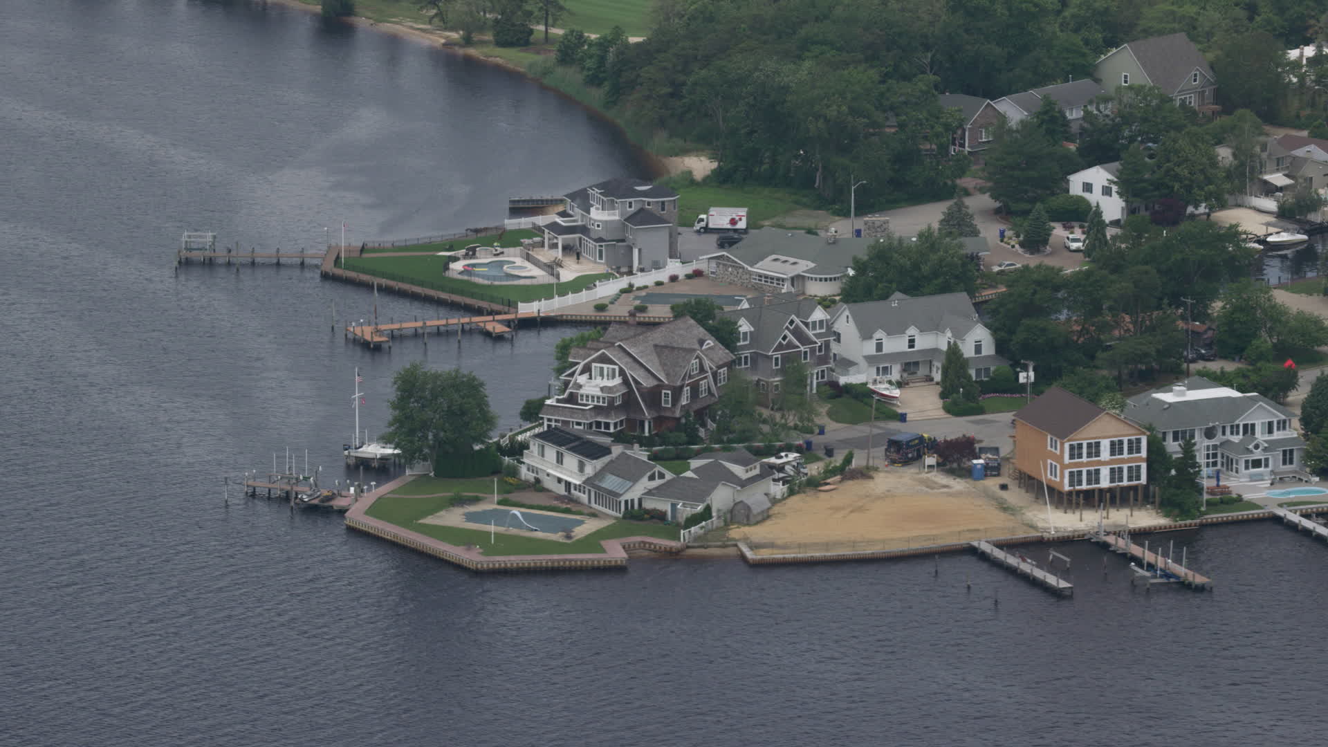 5K stock footage aerial video of upscale riverfront homes with docks