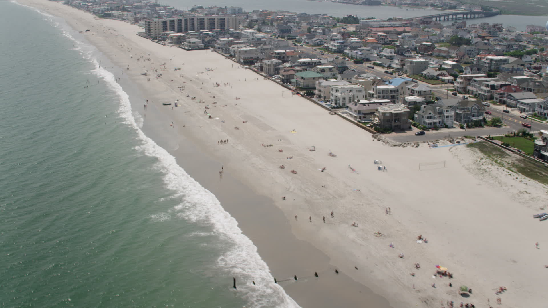 5K stock footage aerial video of beachgoers and beachfront homes and