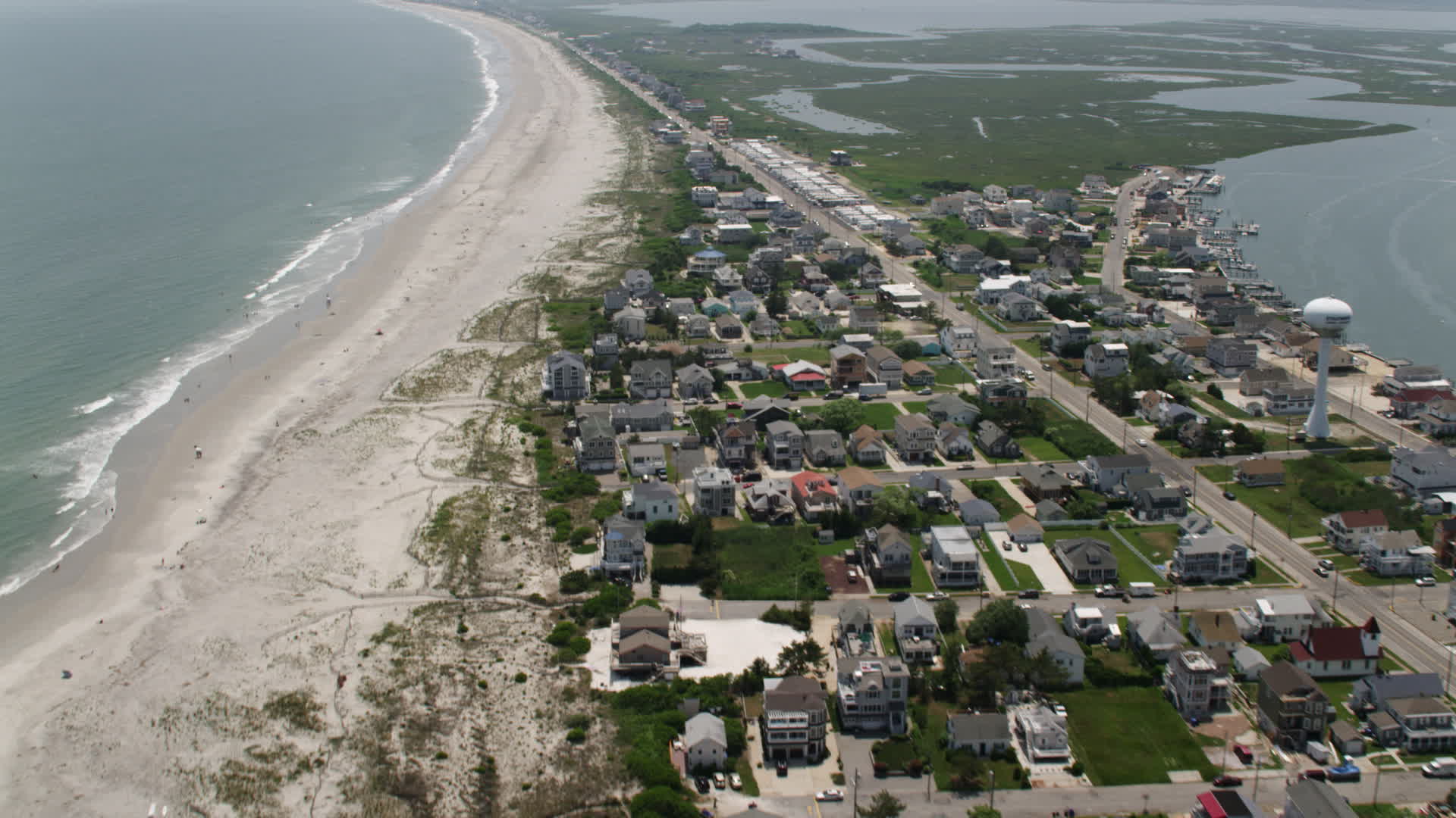 5K stock footage aerial video flying over beachfront homes by RV park