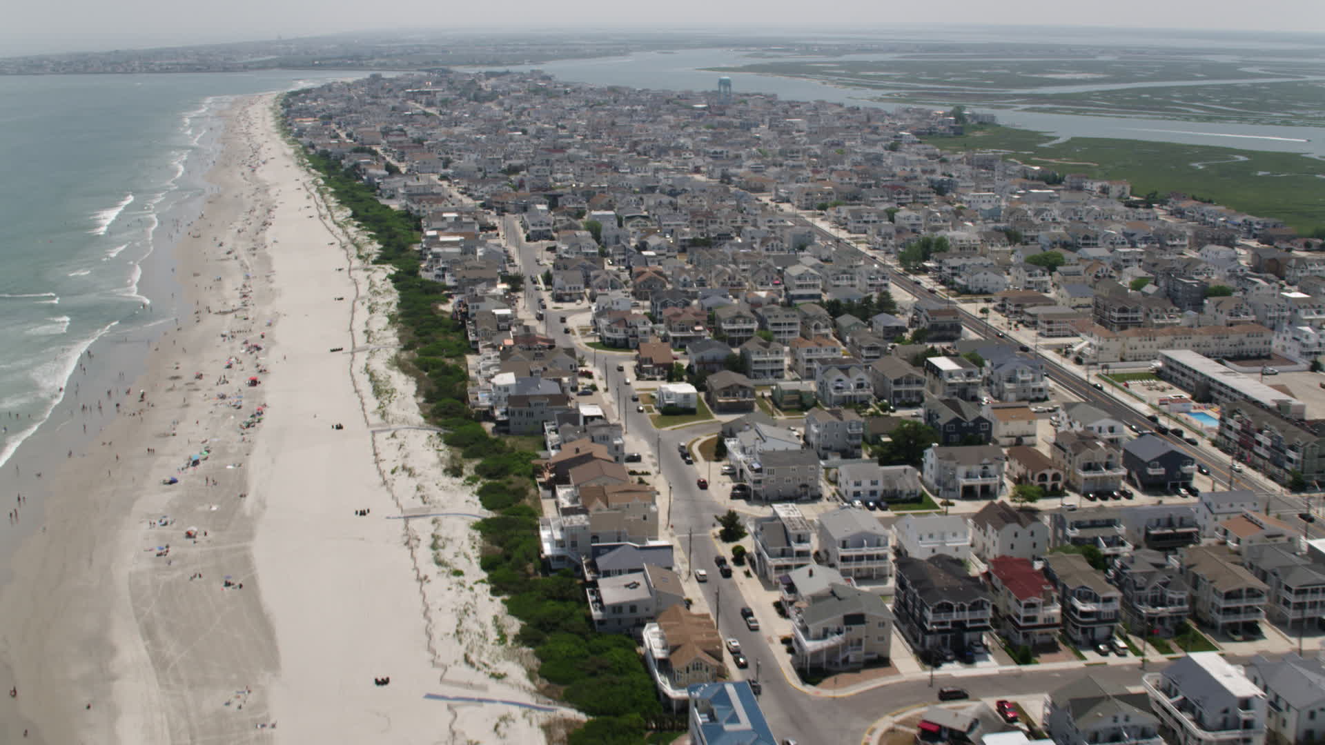 5K stock footage aerial video of beach goers and beachfront
