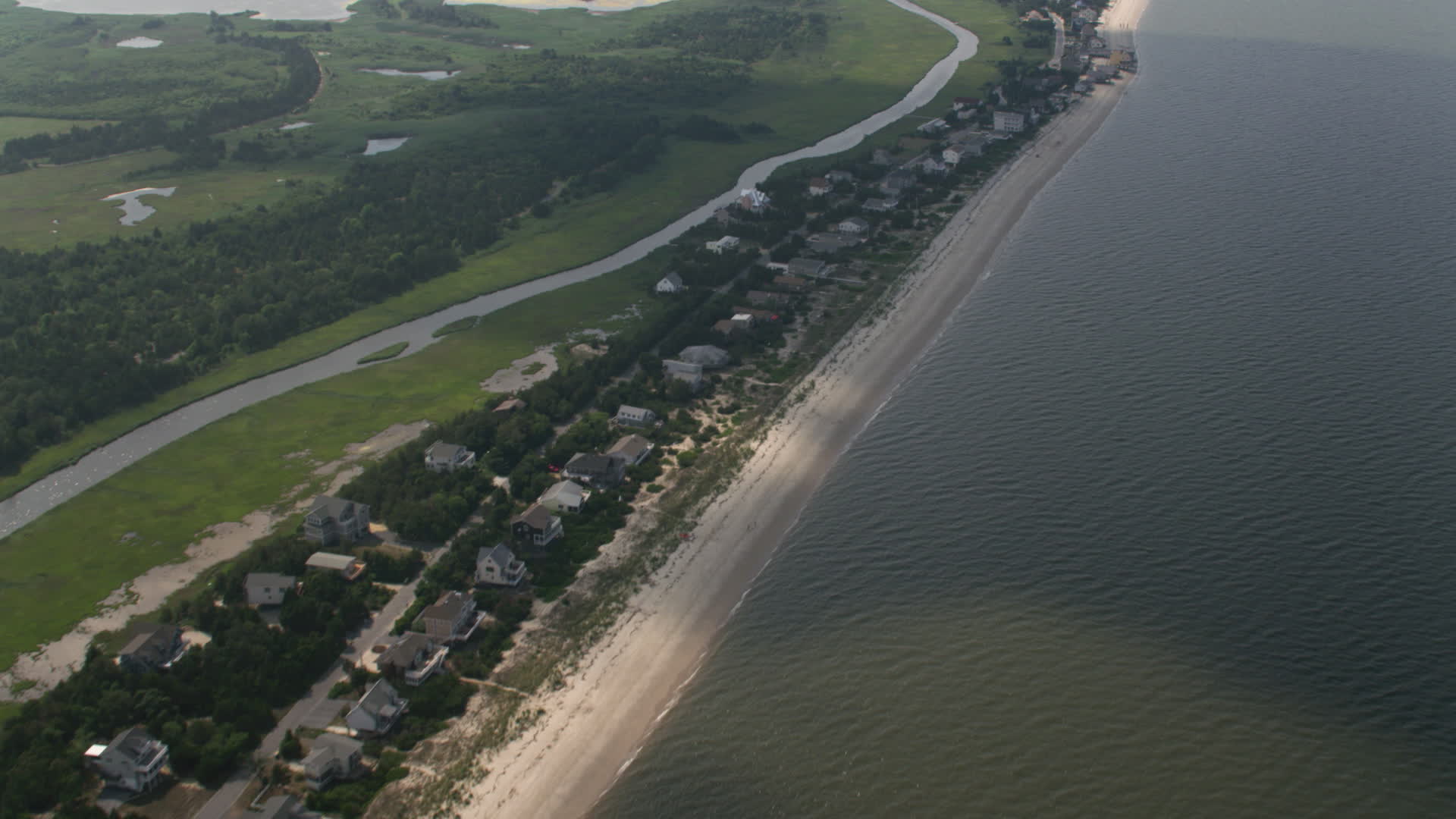 5K stock footage aerial video of beachfront homes and creek in