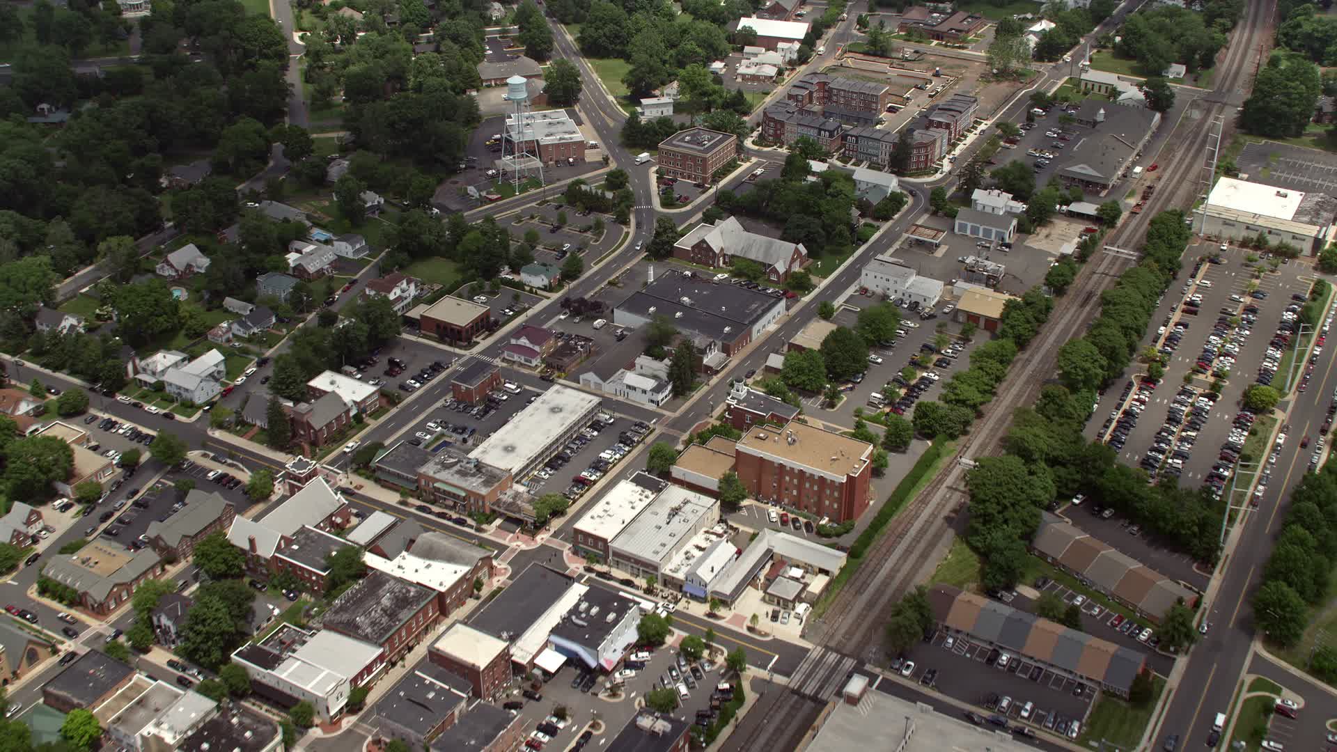 4.8K stock footage aerial video flying over water tower, shops and