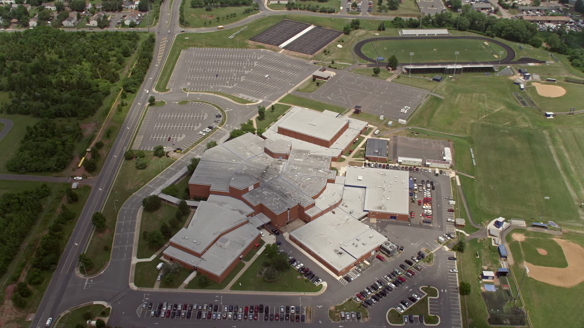 4.8K stock footage aerial video tilting to Bird's Eye of High School in