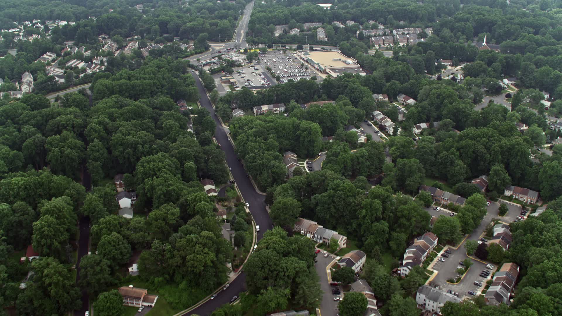 4.8K stock footage aerial video flying over suburban homes to approach