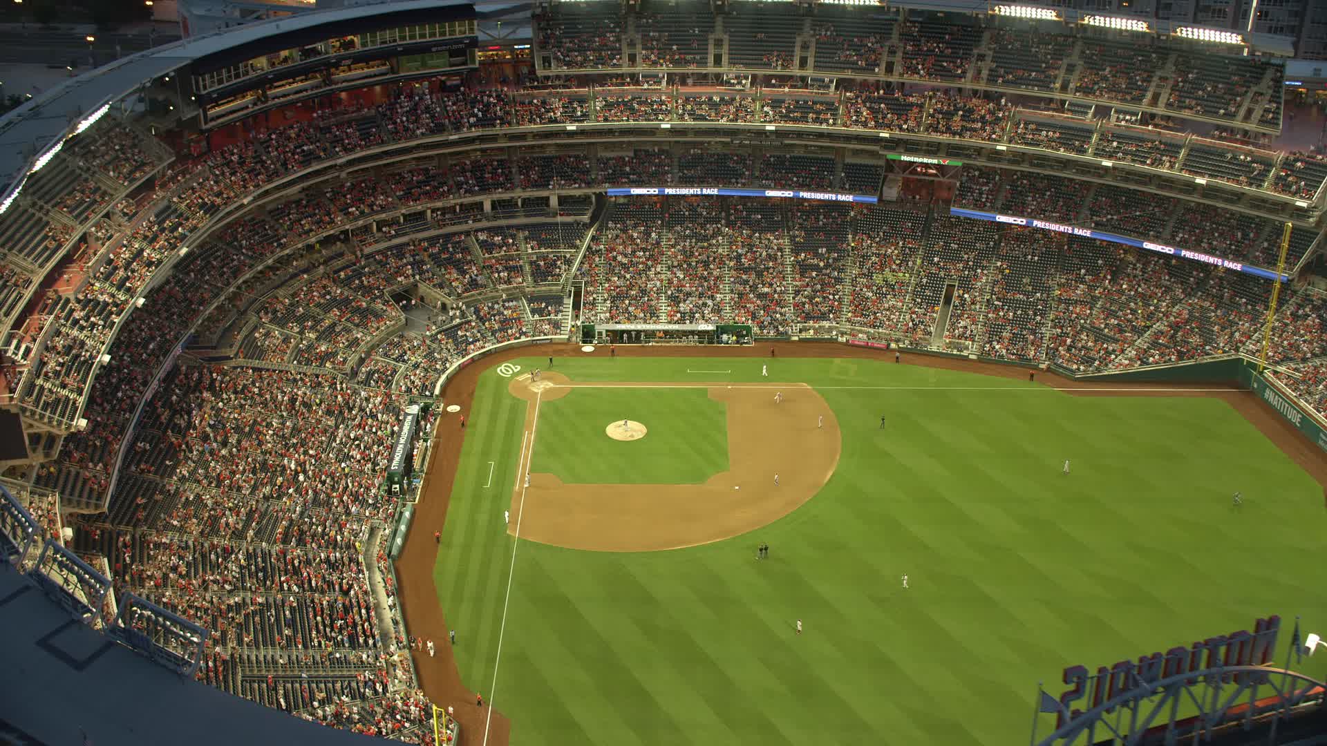 4.8K stock footage aerial video flying by a baseball game at Nationals Park,  Washington, D.C., twilight Aerial Stock Footage AX76_172E | Axiom Images