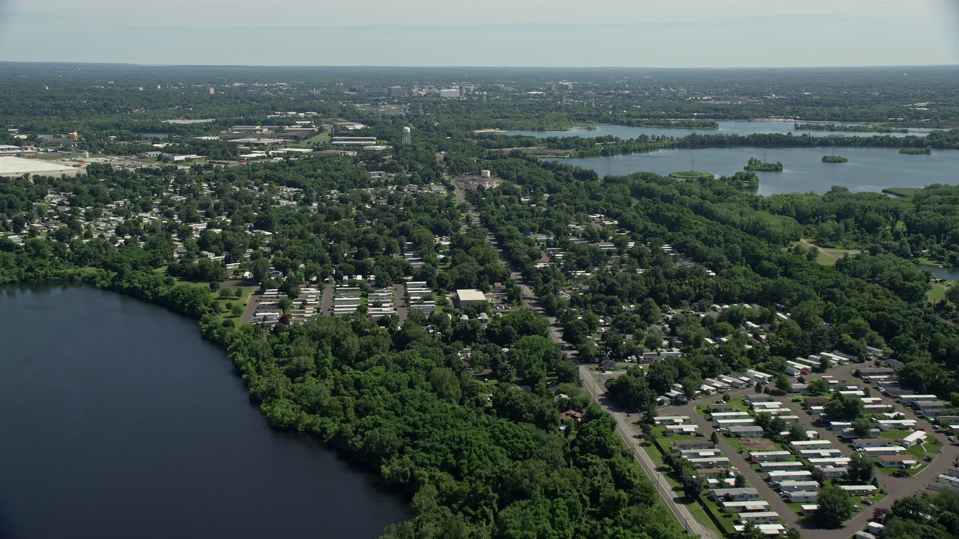 4.8K stock footage aerial video flying over a mobile home park near a lake in Morrisville