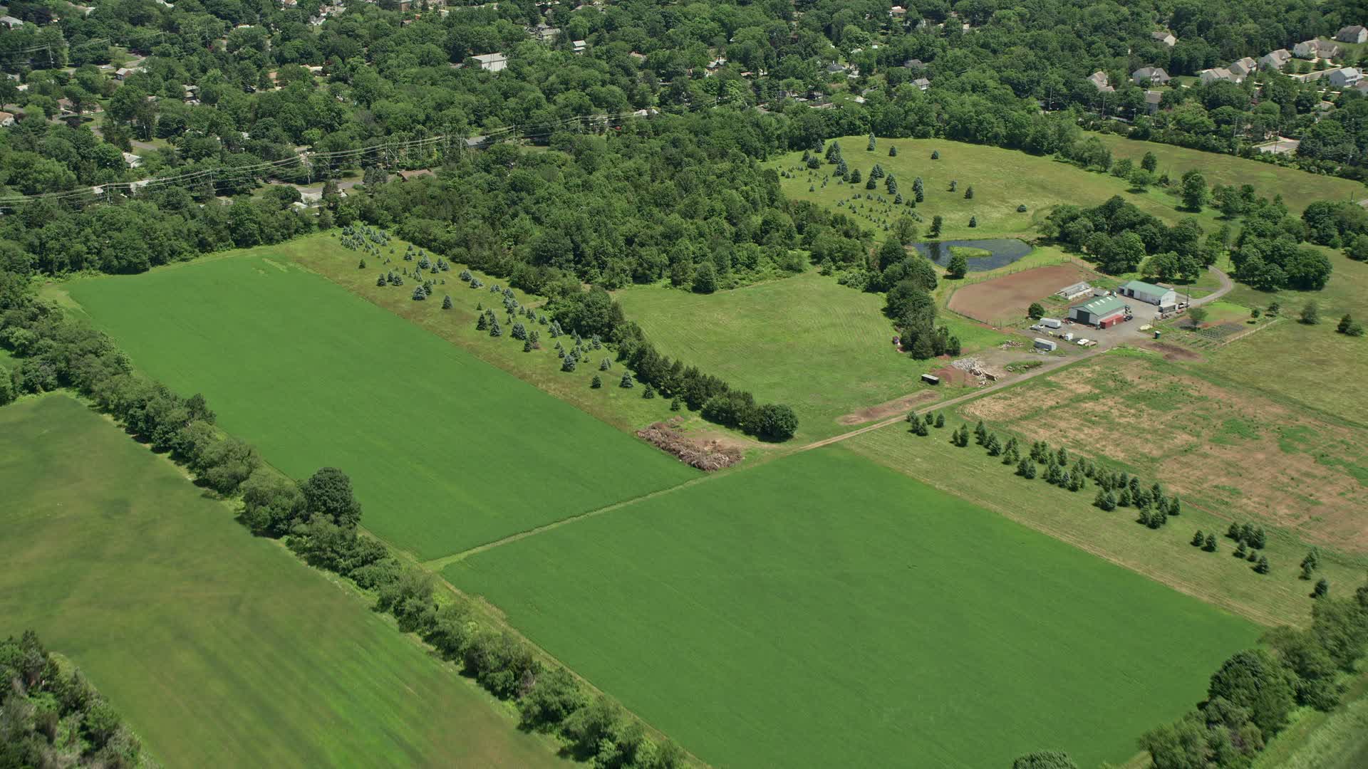 4.8K stock footage aerial video flying over farm fields and small town