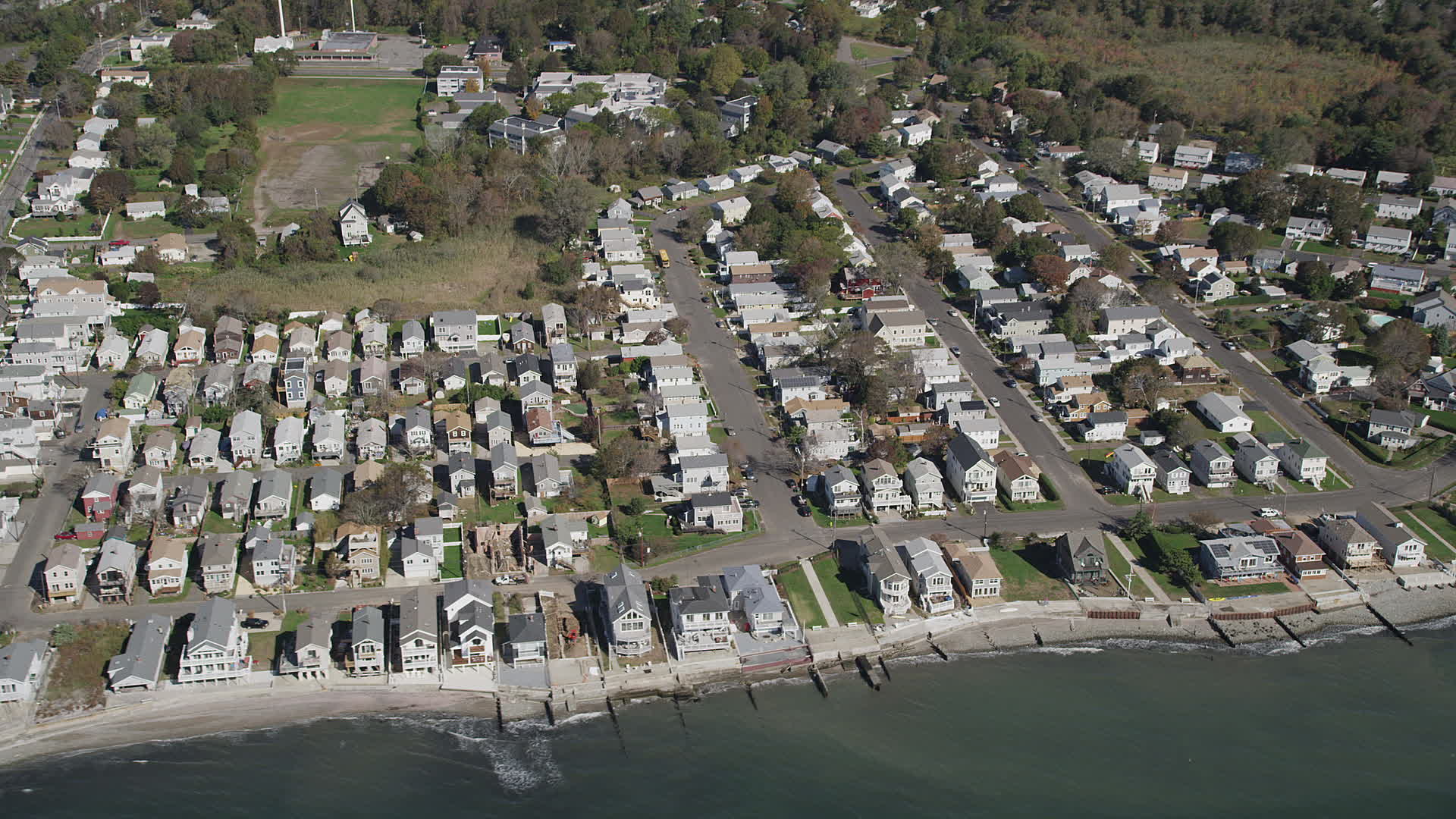 4K stock footage aerial video of passing beachfront homes in Milford