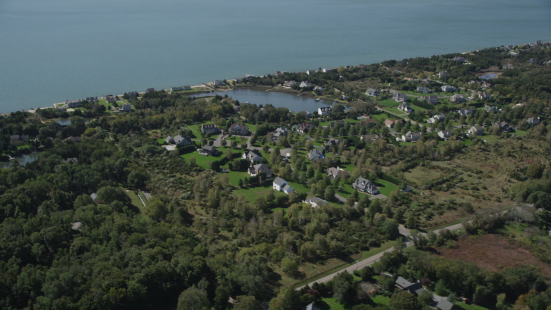 4K stock footage aerial video of flying by upscale homes in a coastal