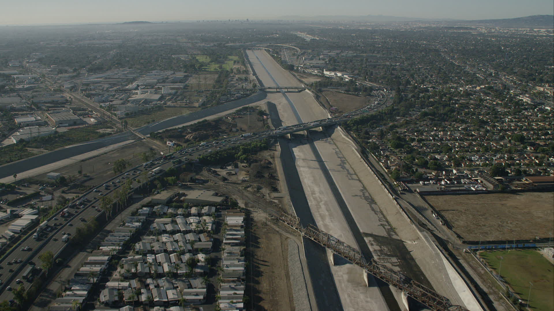 HD stock footage aerial video follow LA River over freeways in South