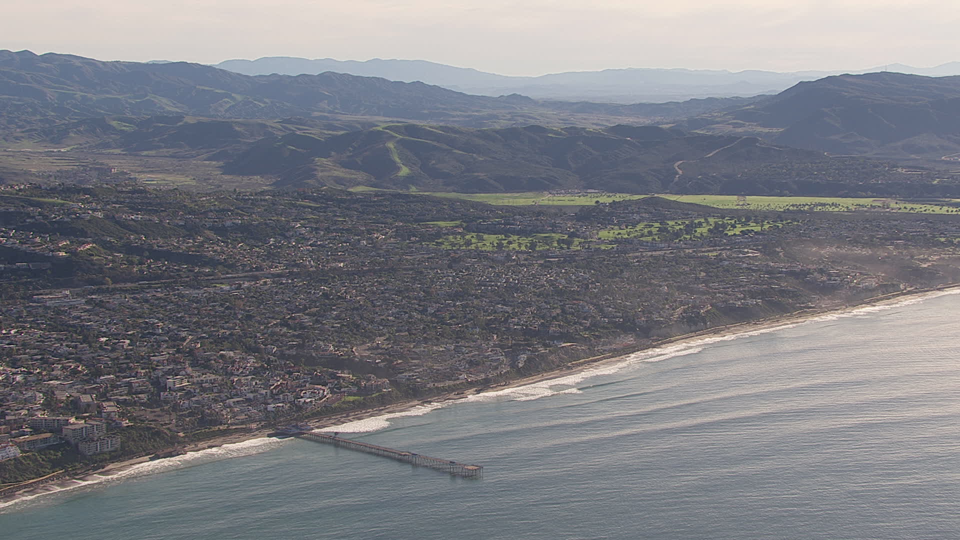 HD stock footage aerial video of a wide view of a pier by coastal