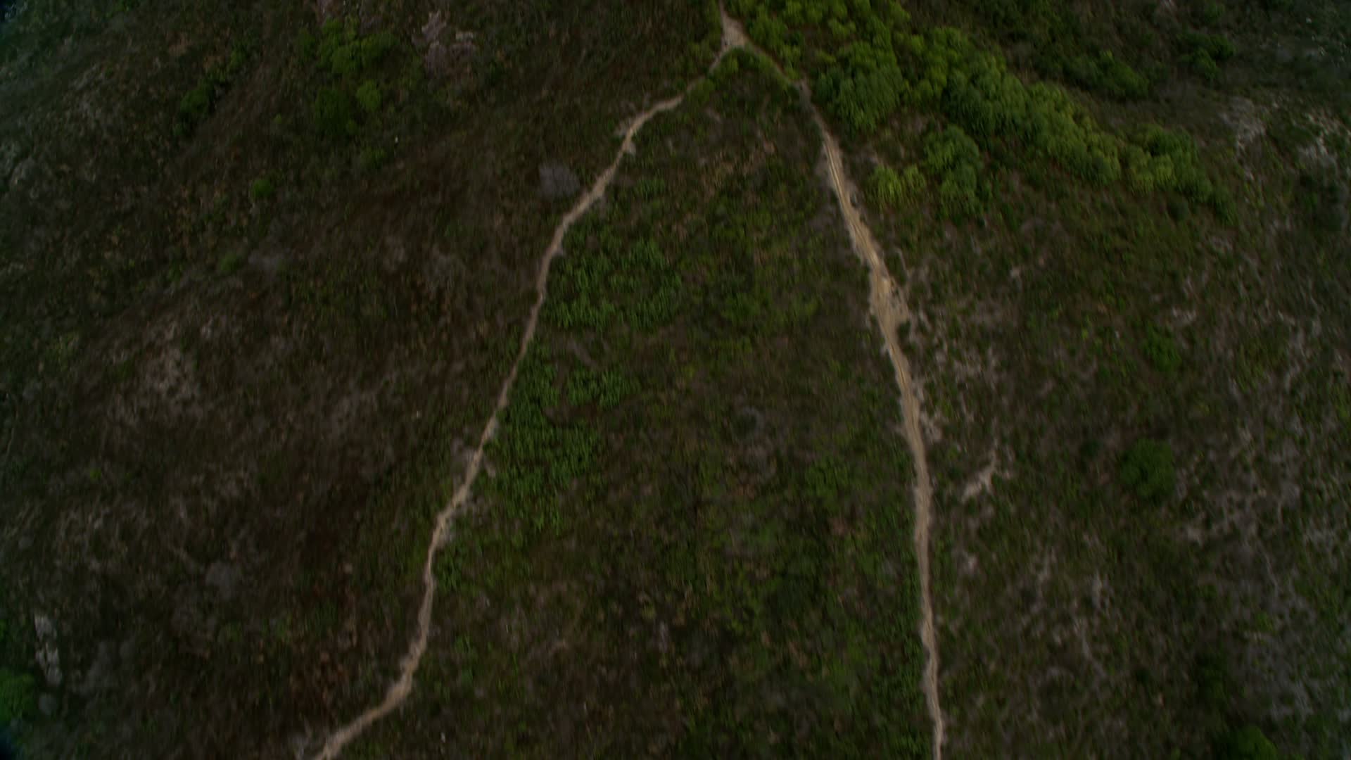 4K stock footage aerial video of a bird's eye view of dirt roads on a