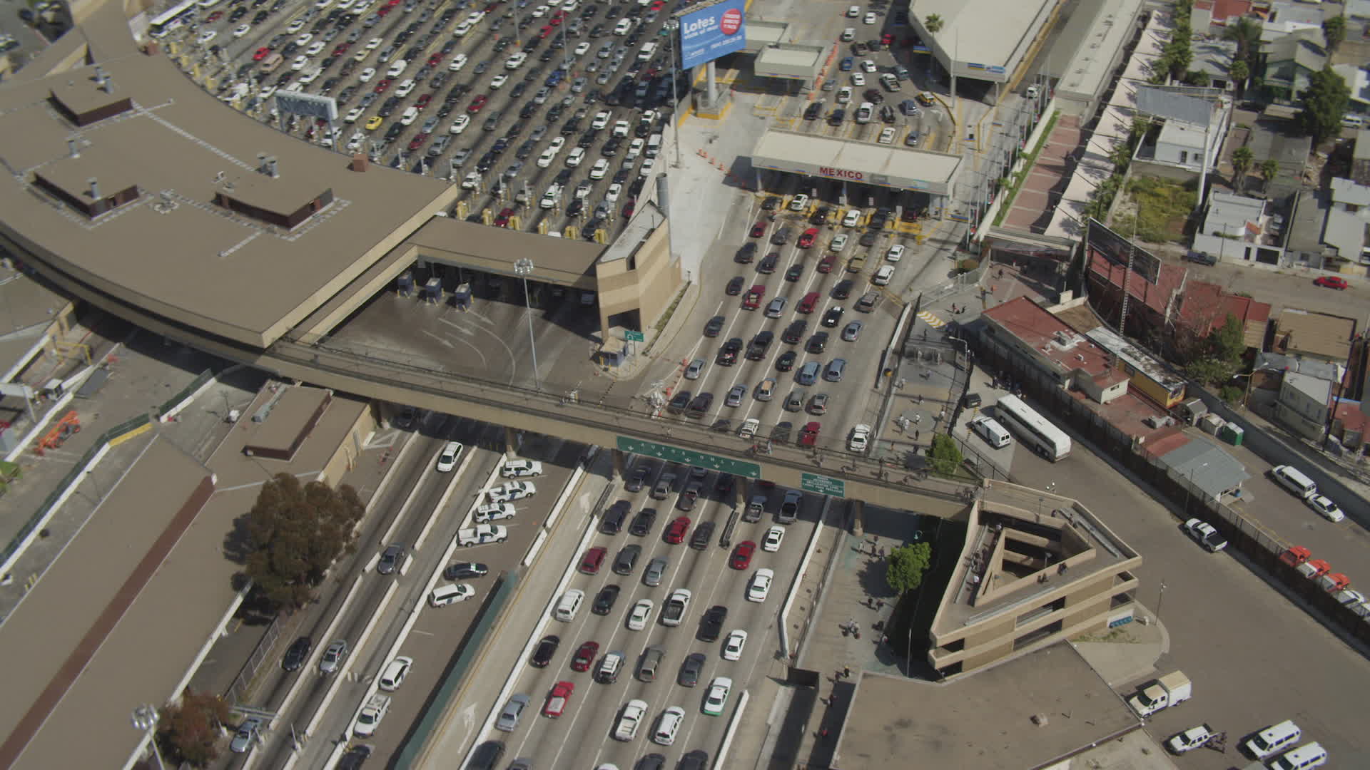 4K stock footage aerial video orbit rows of cars at the US/Mexico