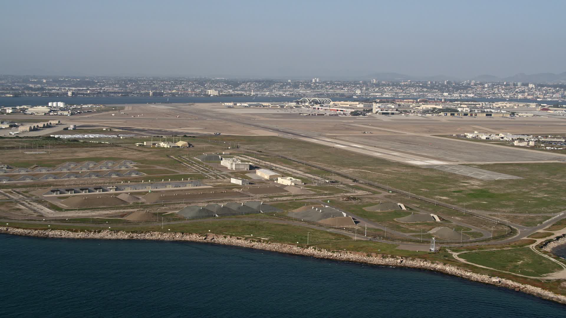 4K stock footage aerial video of bunkers and runways on an island