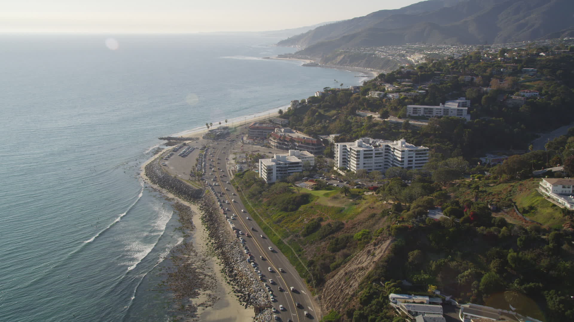 5K stock footage aerial video follow Highway 1 to approach condos in