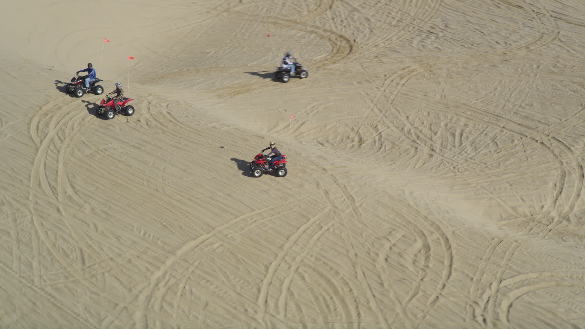 5K stock footage aerial video orbiting ATV riders on the sand dunes