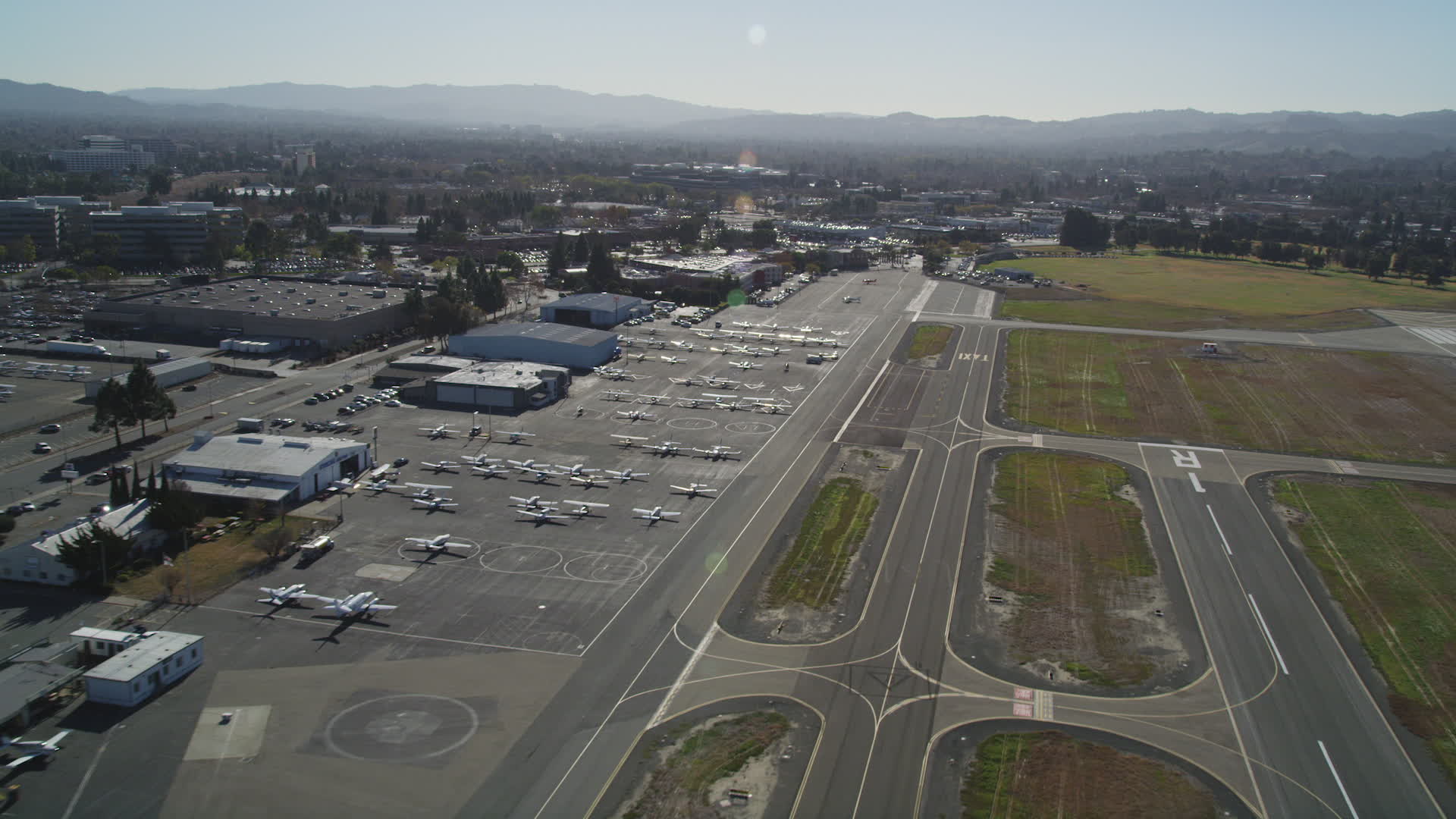 5K stock footage aerial video of passing parked airplanes and hangars