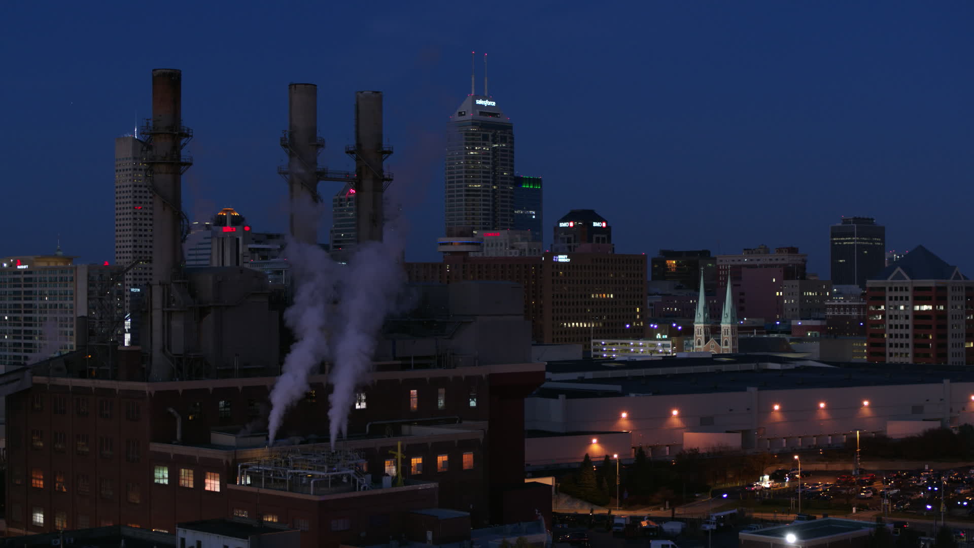 5.7K stock footage aerial video descend by factory smoke stacks with