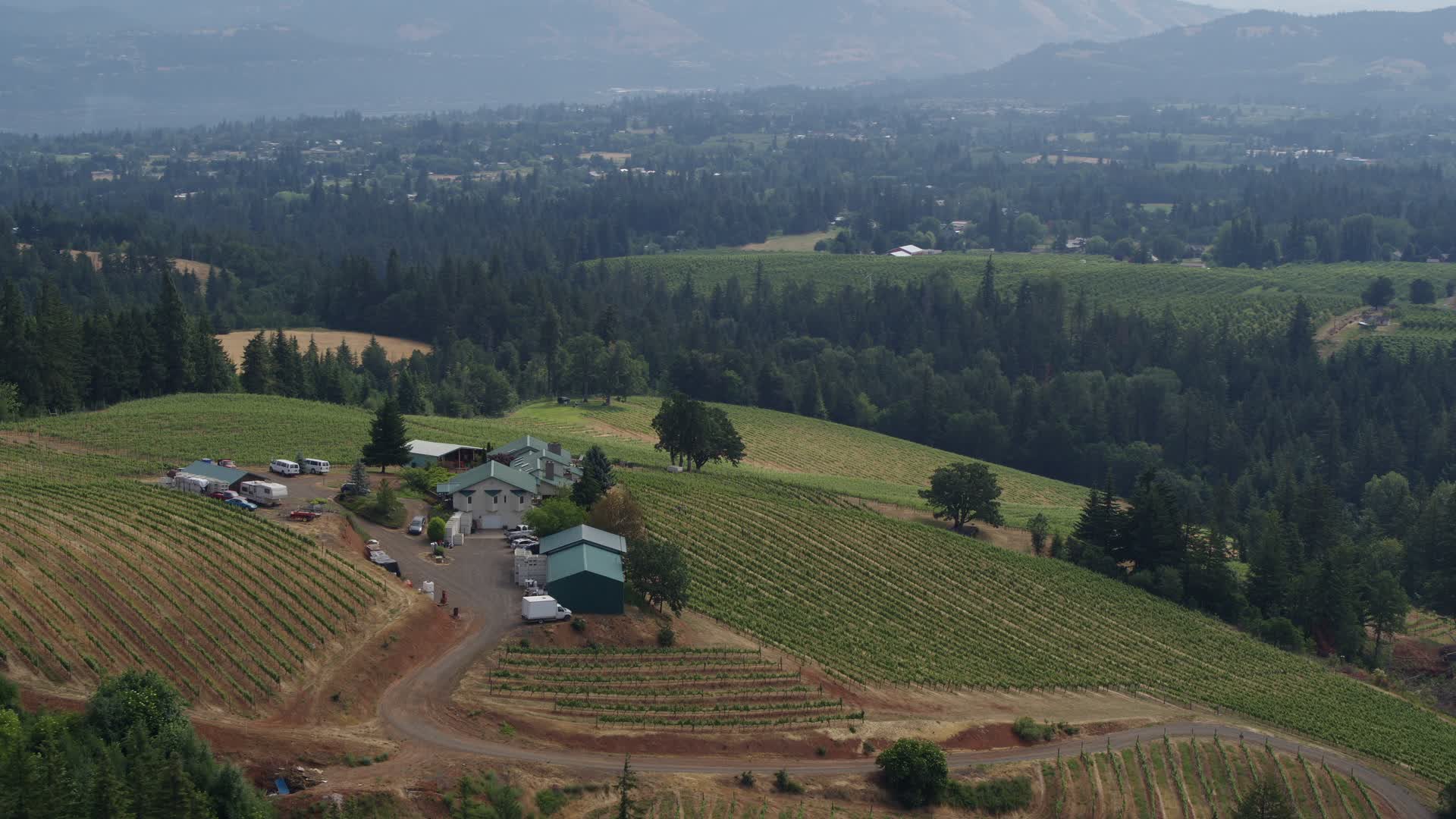 5.7K stock footage aerial video of a reverse view of the Phelps Creek Vineyards with mountains