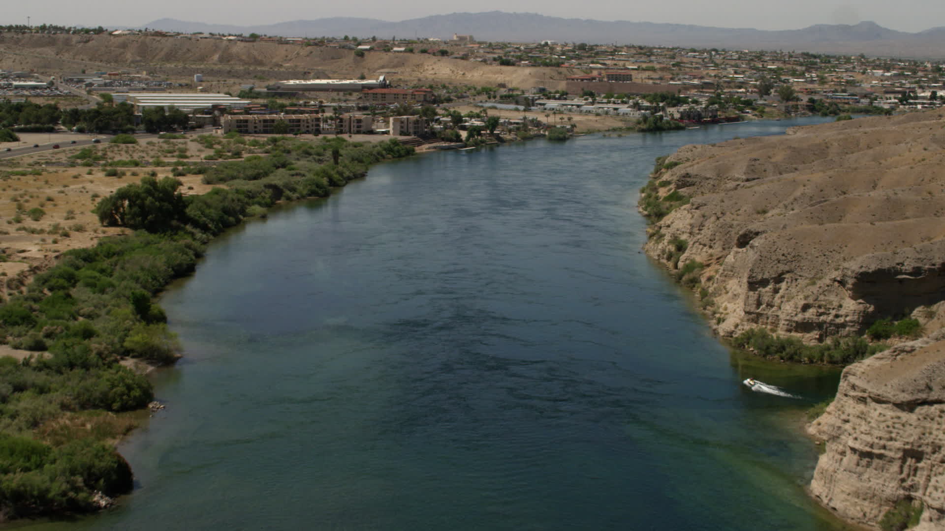 4K stock footage aerial video follow the Colorado River past a small