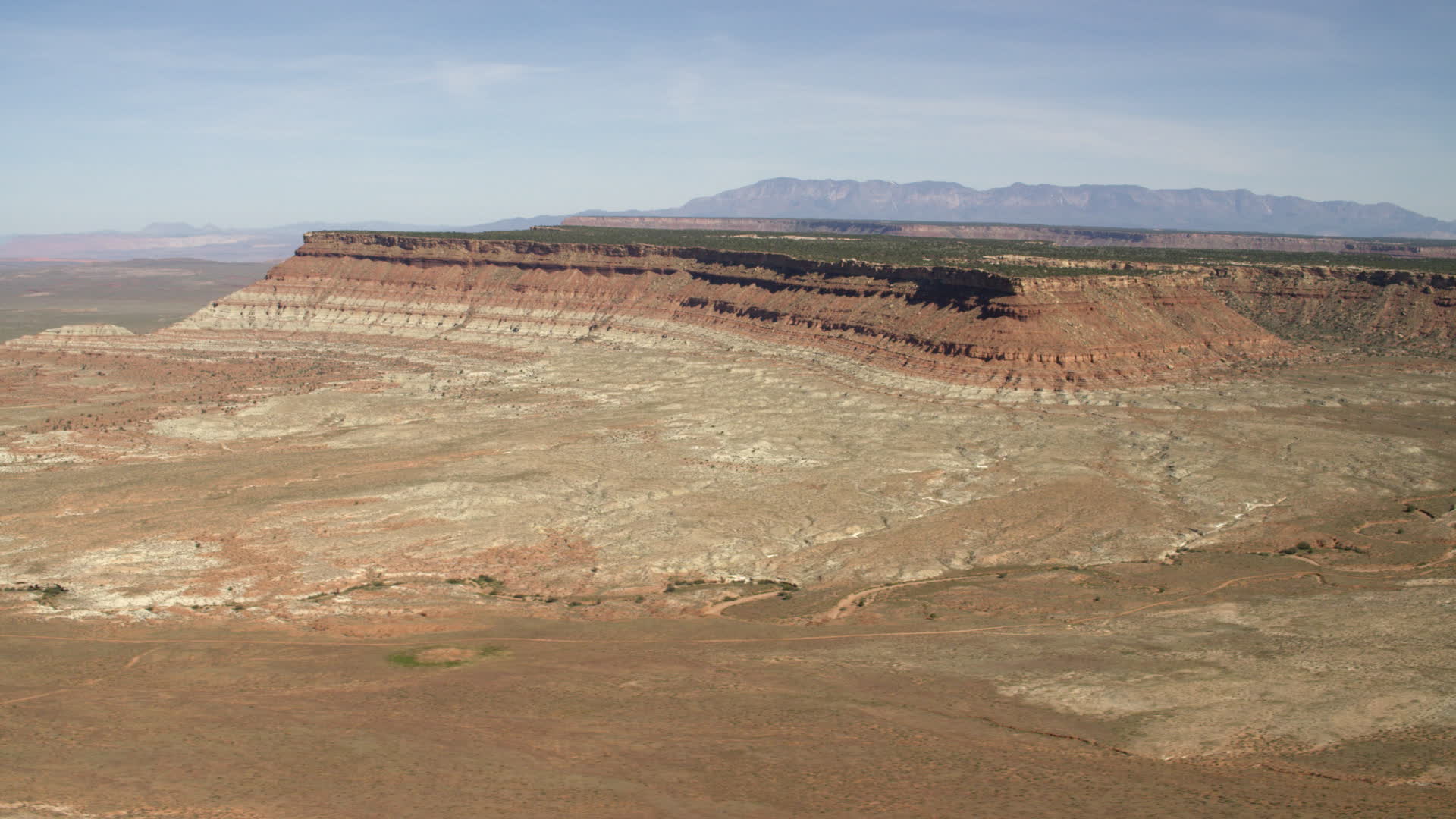 4K stock footage aerial video of a mesa seen across a desert plain in