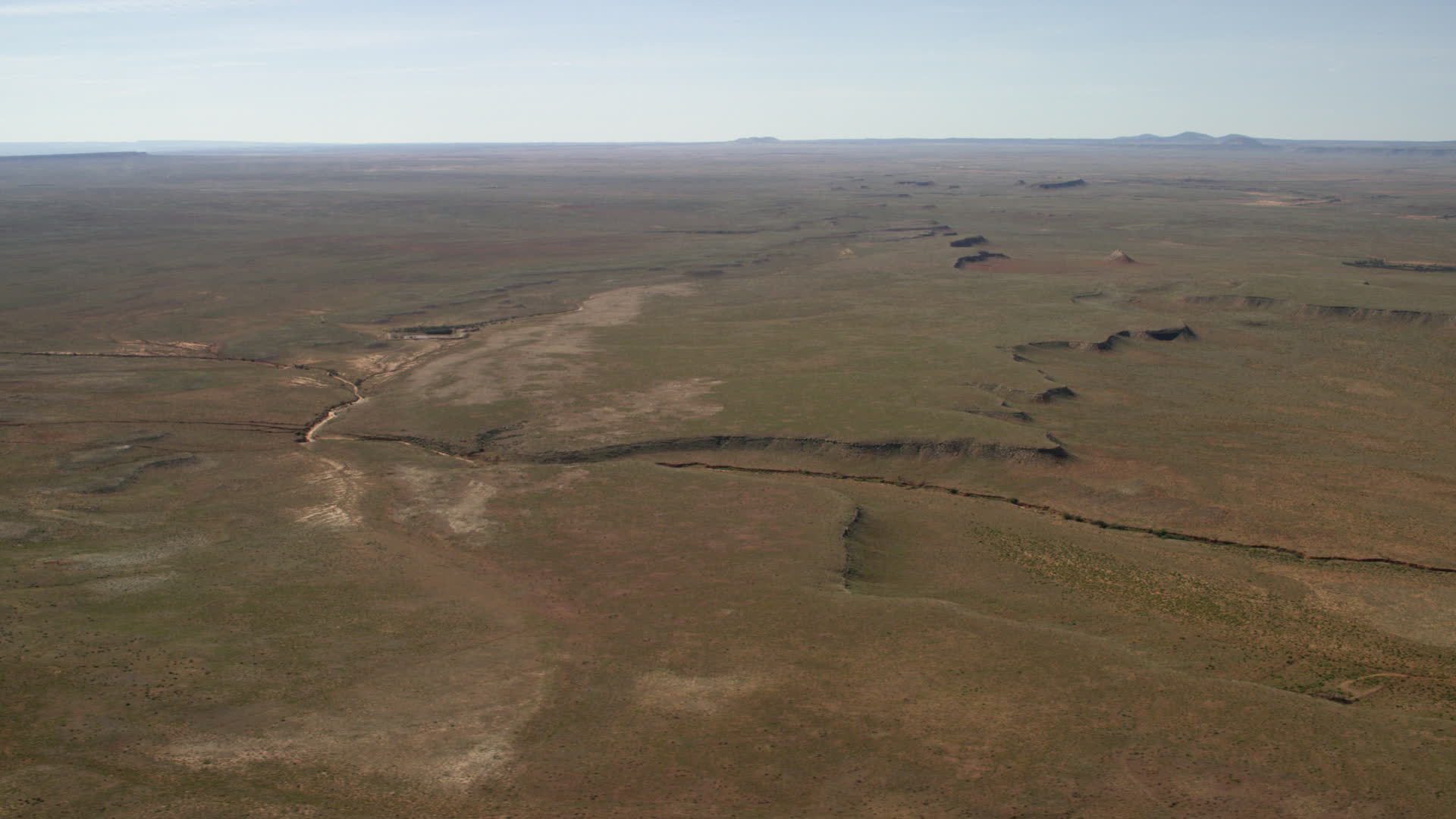 4K stock footage aerial video of a dry riverbed and a desert plain in