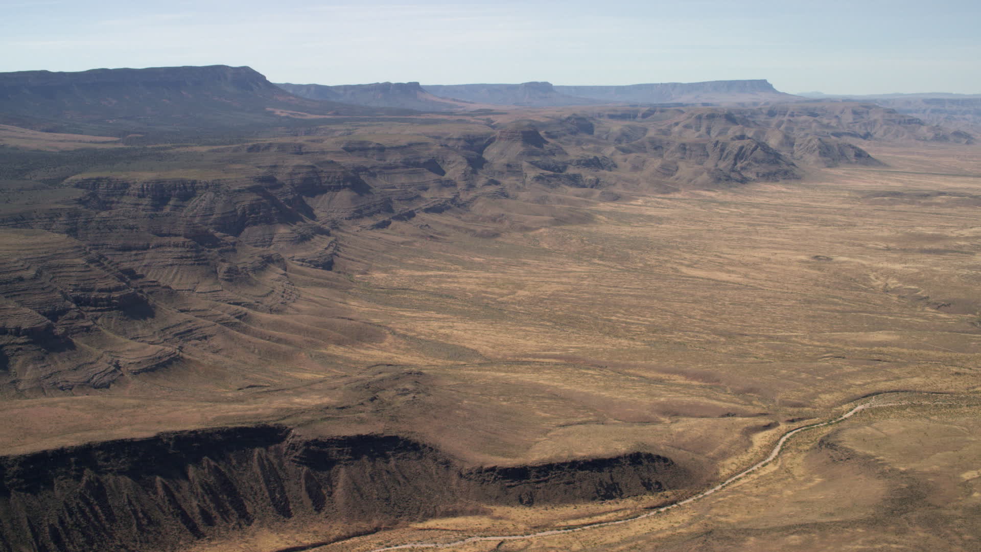 4K stock footage aerial video of rugged mesas overlooking a wide plain