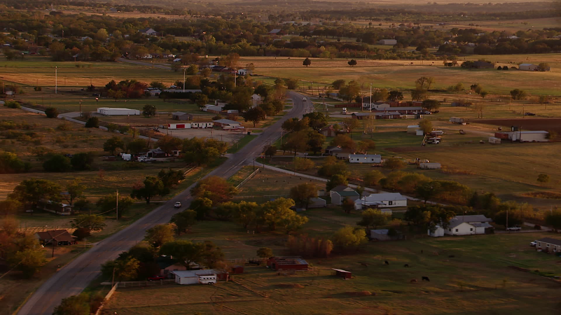 1080 stock footage aerial video of a small rural town at sunset in