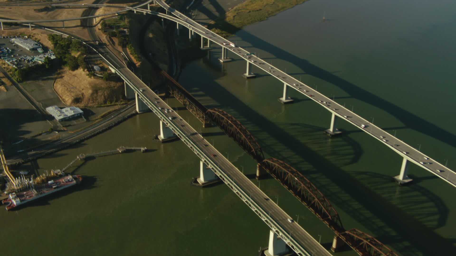 1080 stock footage aerial video follow BeniciaMartinez Bridge, tilt to
