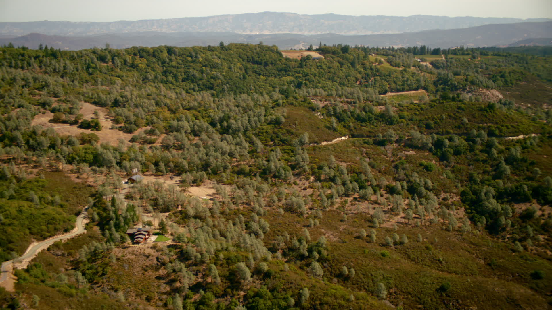 1080 stock footage aerial video of pan from home and hills to reveal